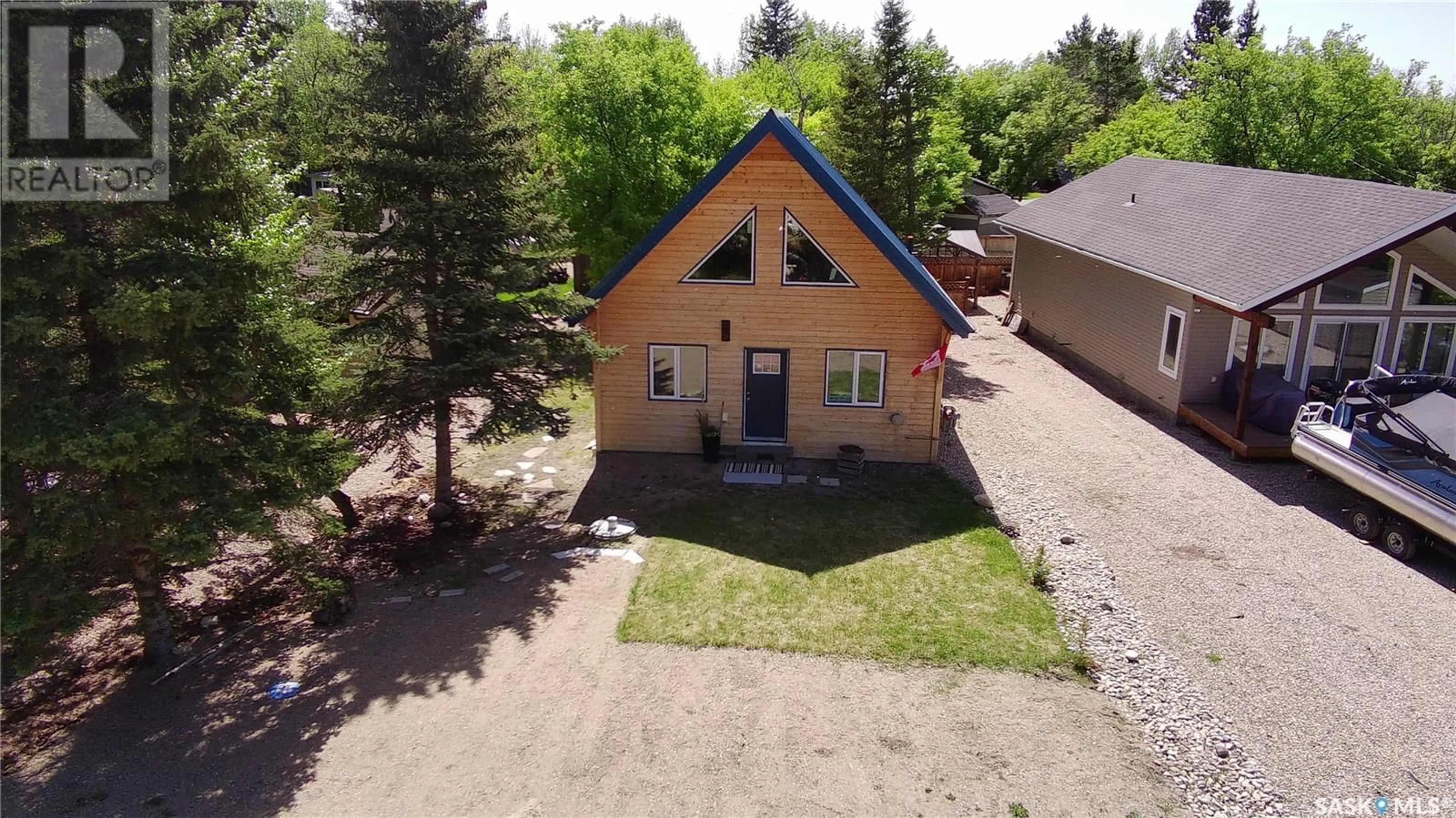 A pic from outside/outdoor area/front of a property/back of a property/a pic from drone, unknown for 511 EVINRUDE AVENUE, Aquadeo Saskatchewan S0M0L0
