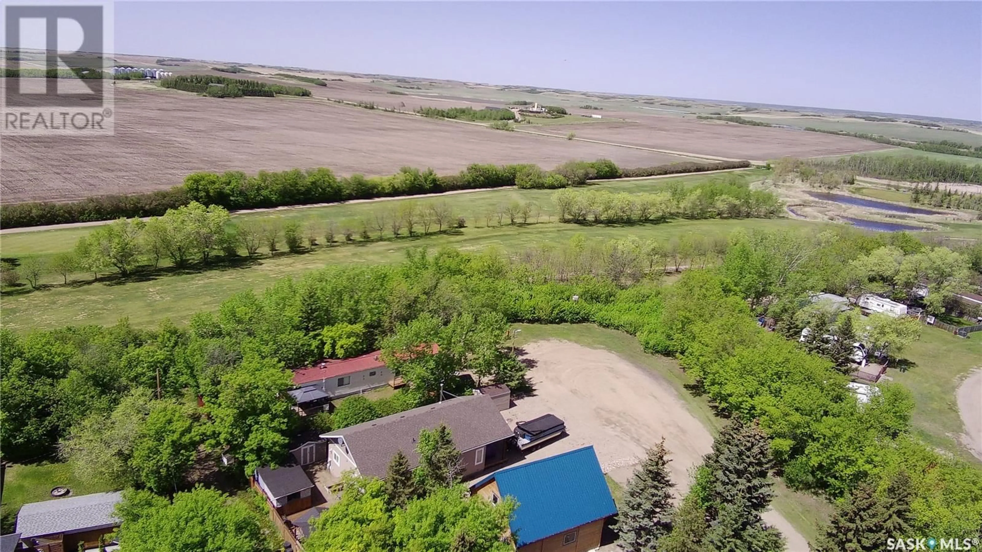 A pic from outside/outdoor area/front of a property/back of a property/a pic from drone, unknown for 511 EVINRUDE AVENUE, Aquadeo Saskatchewan S0M0L0