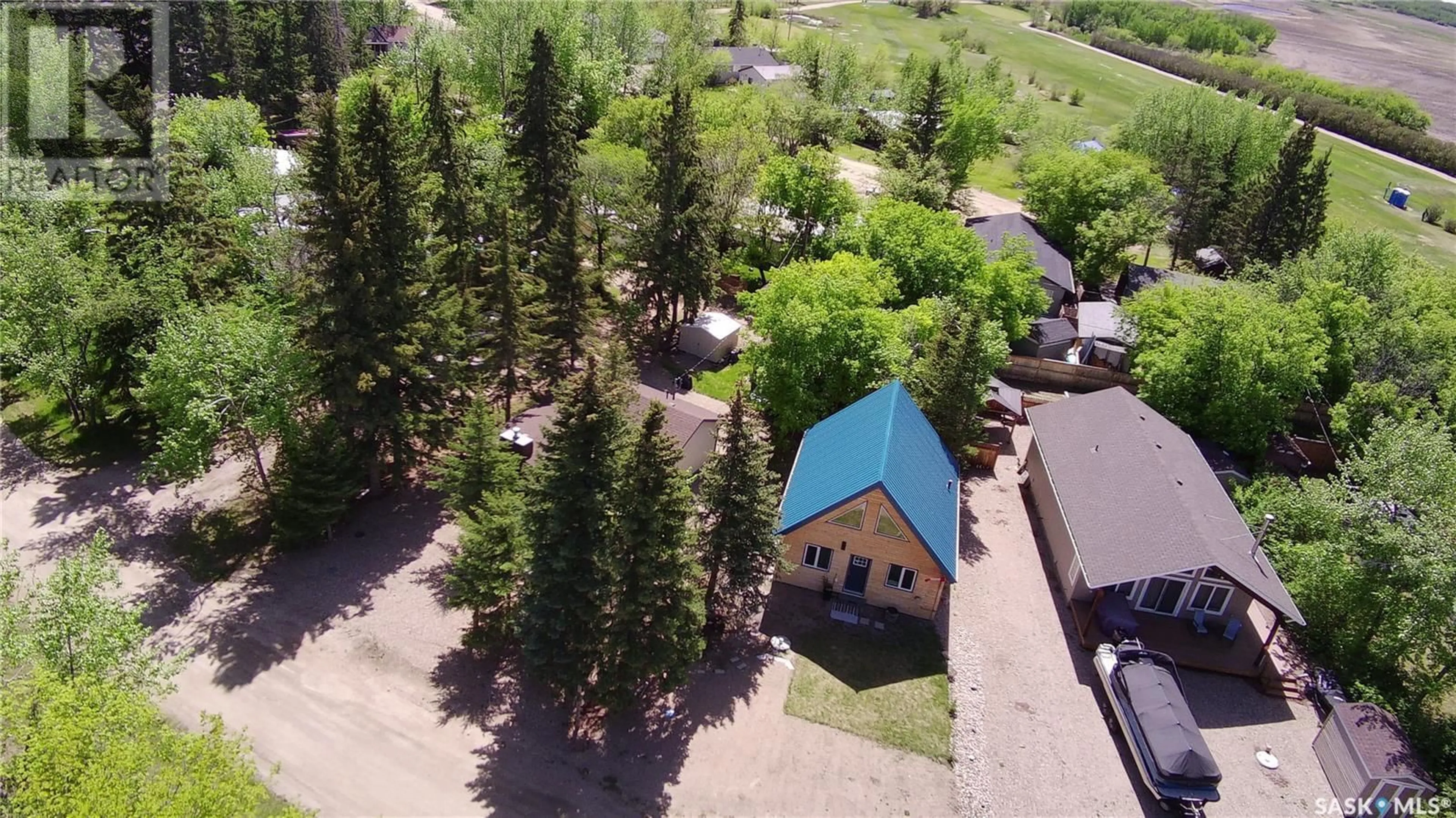 A pic from outside/outdoor area/front of a property/back of a property/a pic from drone, mountain view for 511 EVINRUDE AVENUE, Aquadeo Saskatchewan S0M0L0