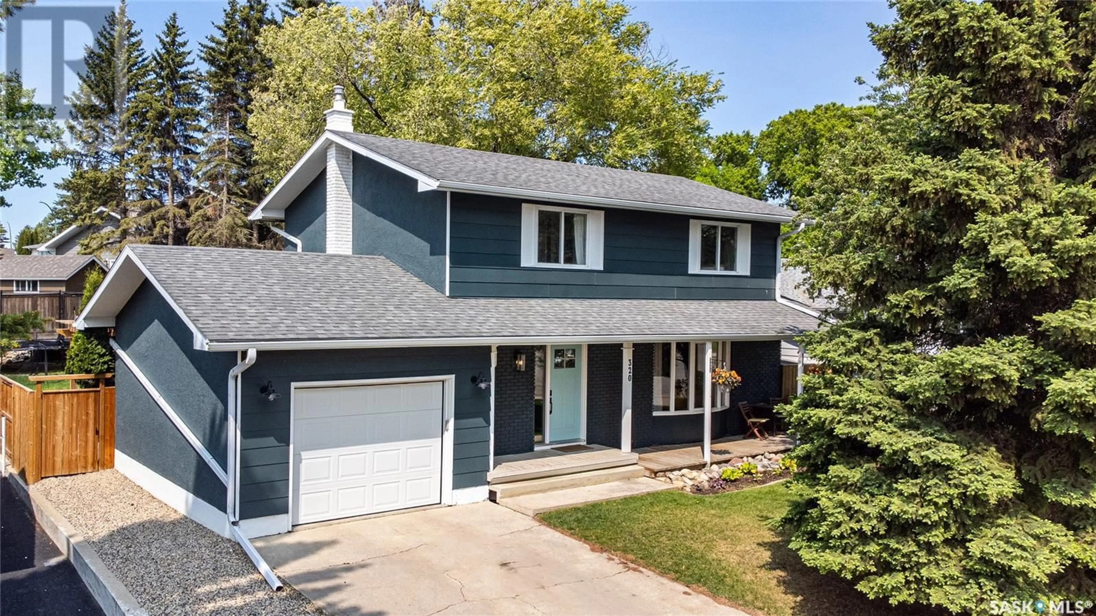 Home with vinyl exterior material, street for 320 NAHANNI DRIVE, Saskatoon Saskatchewan S7K4C7