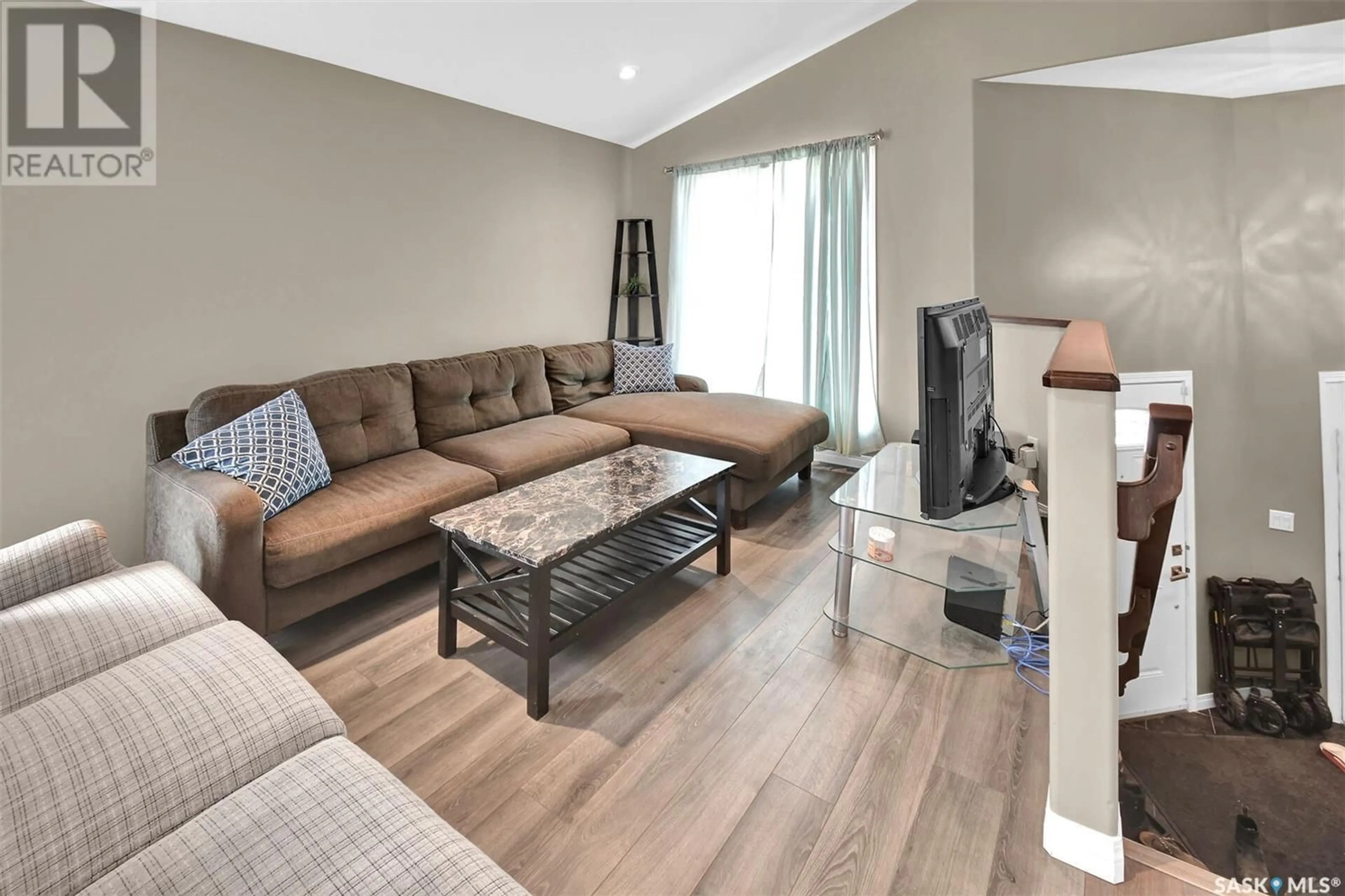 Living room with furniture, wood/laminate floor for 1123 WERSCHNER CRESCENT, Saskatoon Saskatchewan S7V0A7
