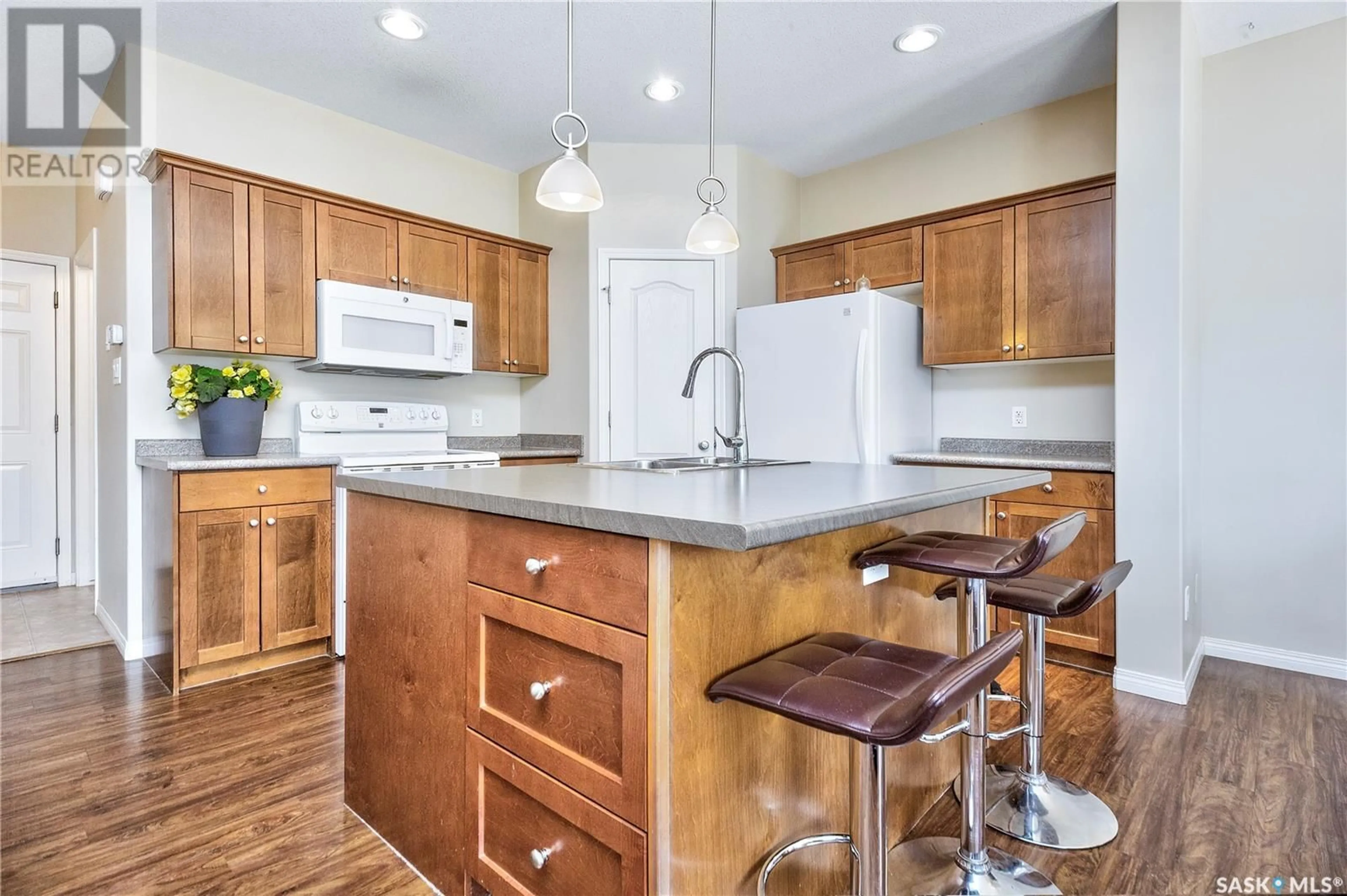 Open concept kitchen, wood/laminate floor for 67 JACK MATHESON CRESCENT, Prince Albert Saskatchewan S6V8E5