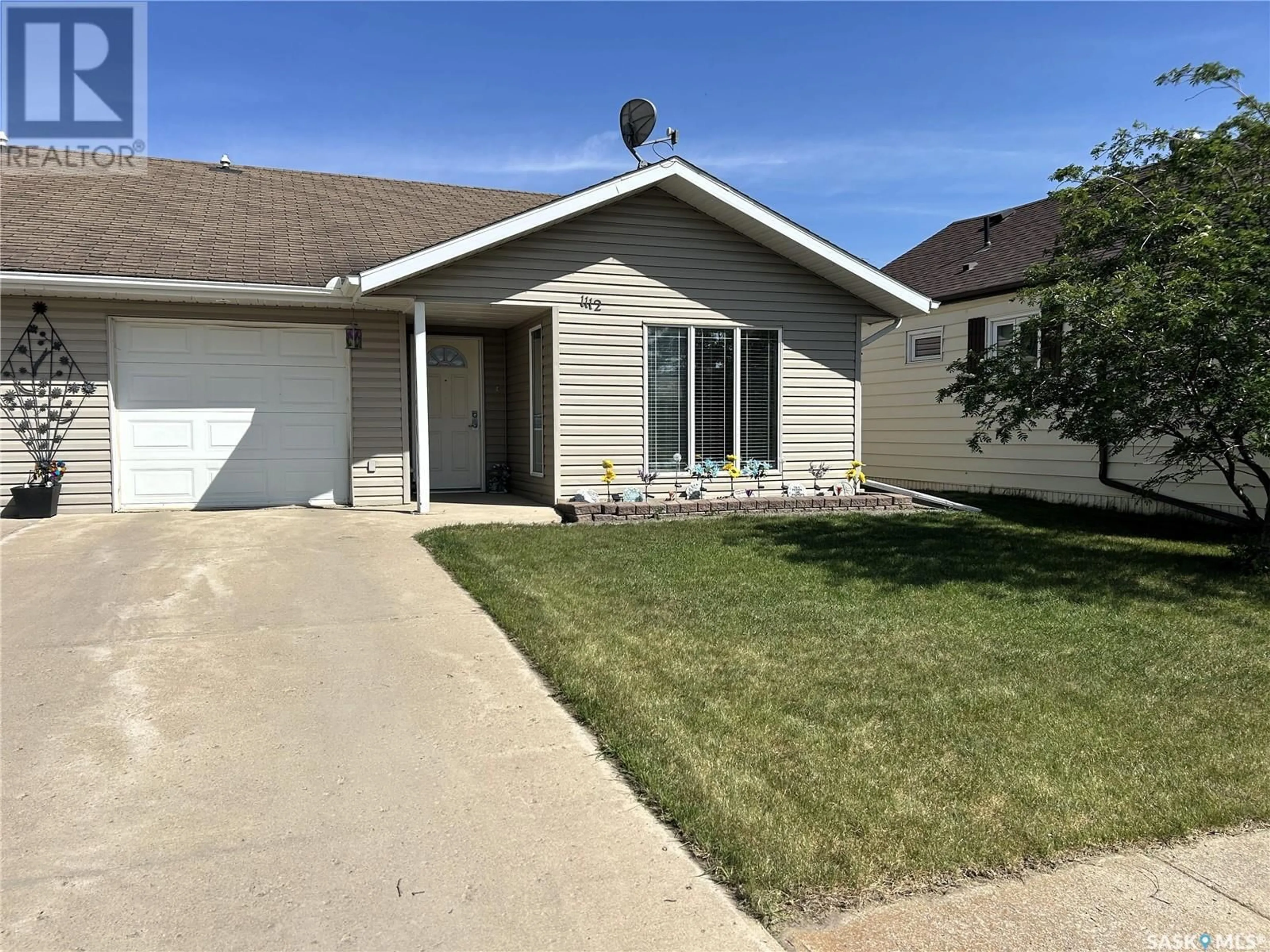 Home with vinyl exterior material, street for 1112 97TH STREET, Tisdale Saskatchewan S0E1T0