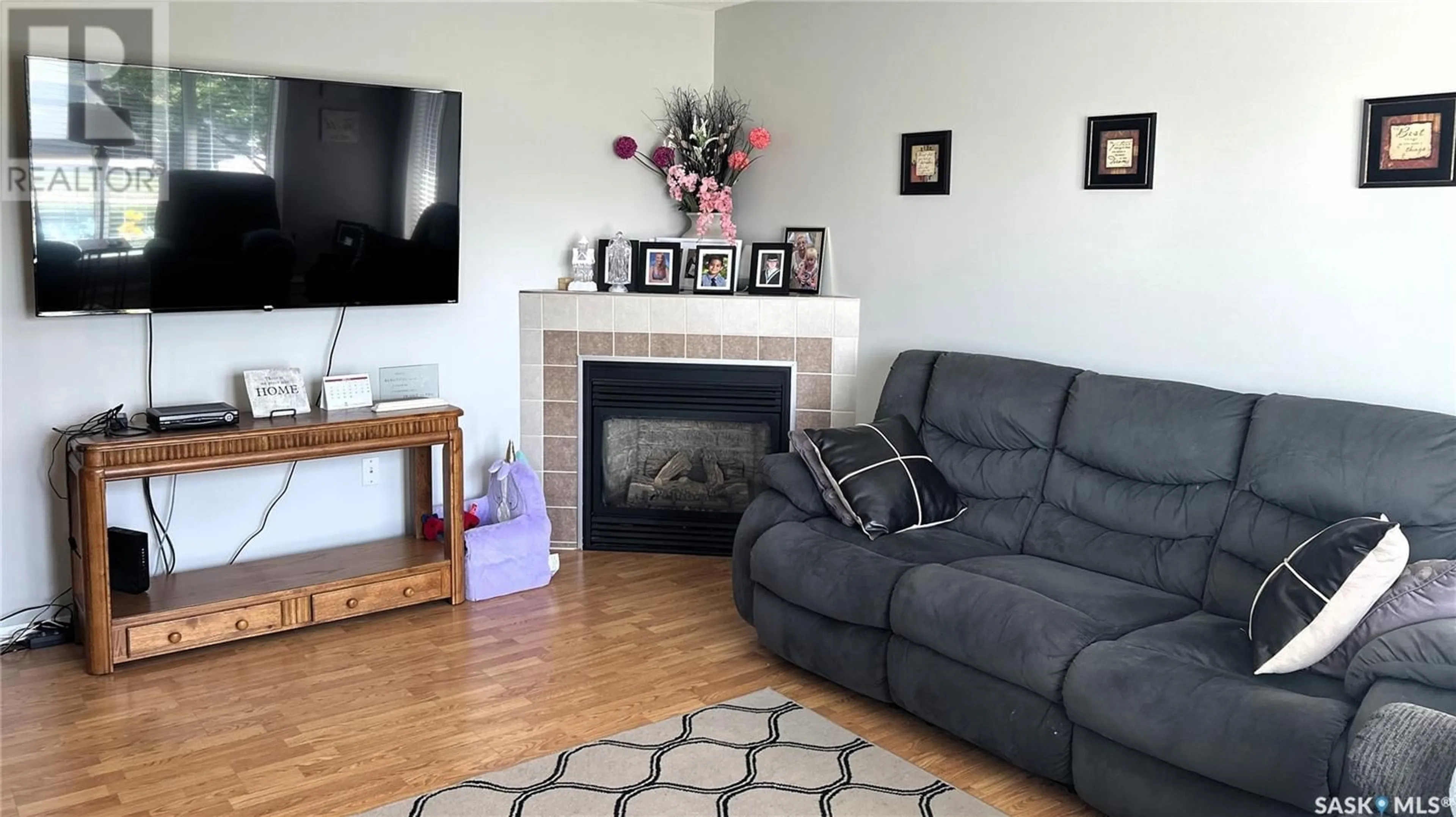 Living room with furniture, wood/laminate floor for 1112 97TH STREET, Tisdale Saskatchewan S0E1T0