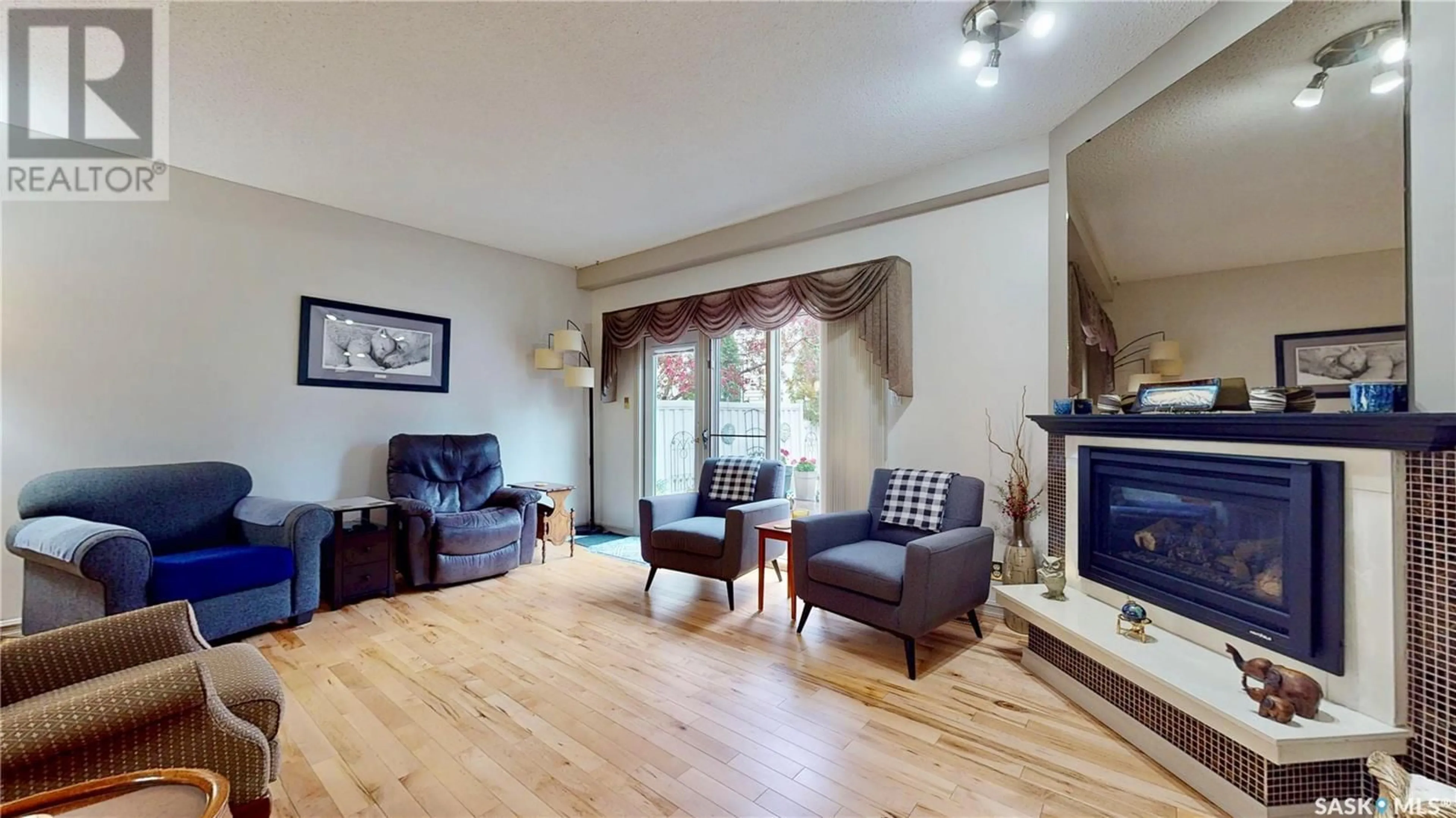 Living room with furniture, wood/laminate floor for 3903 GORDON ROAD, Regina Saskatchewan S4S6G6