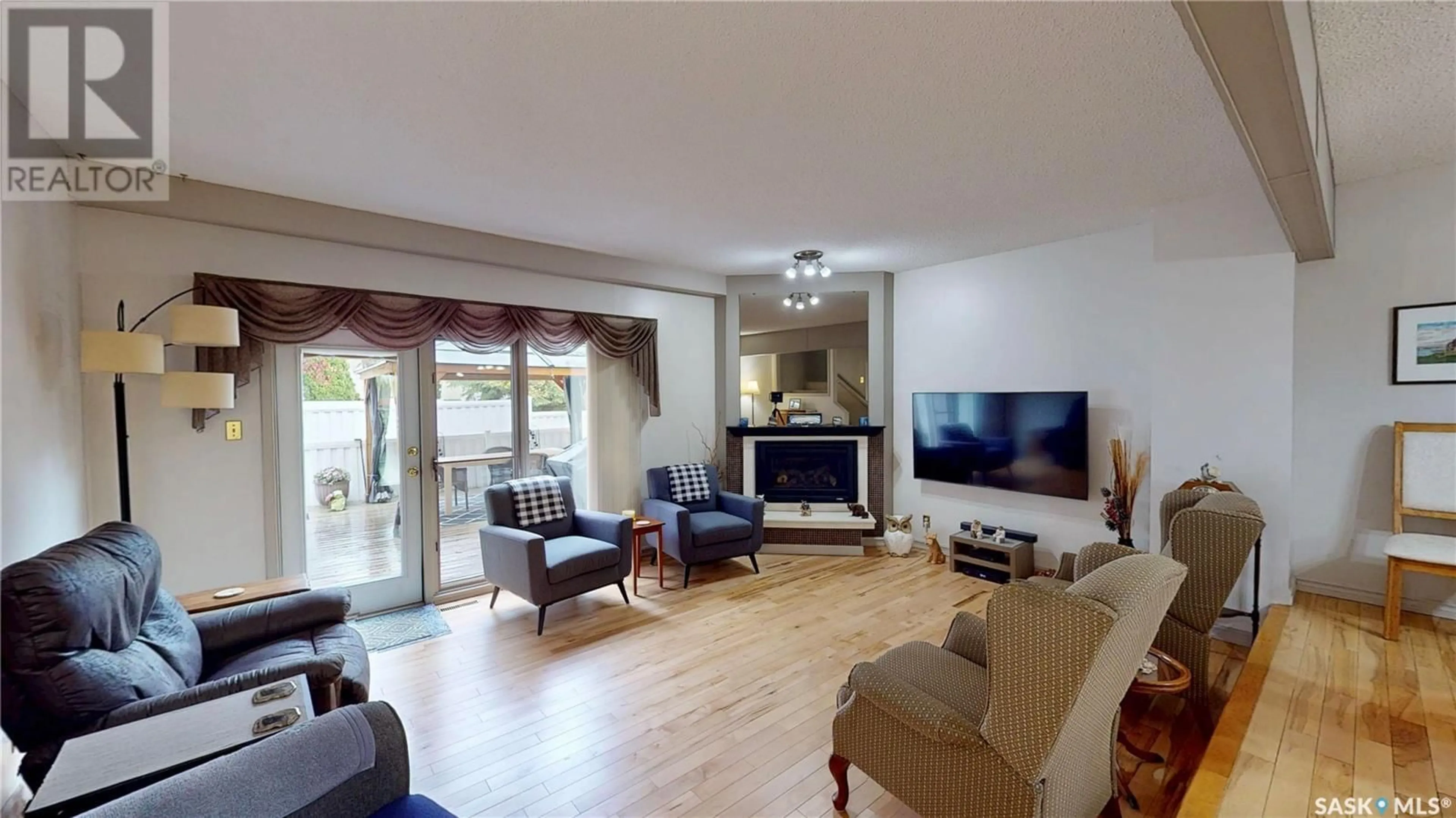 Living room with furniture, wood/laminate floor for 3903 GORDON ROAD, Regina Saskatchewan S4S6G6