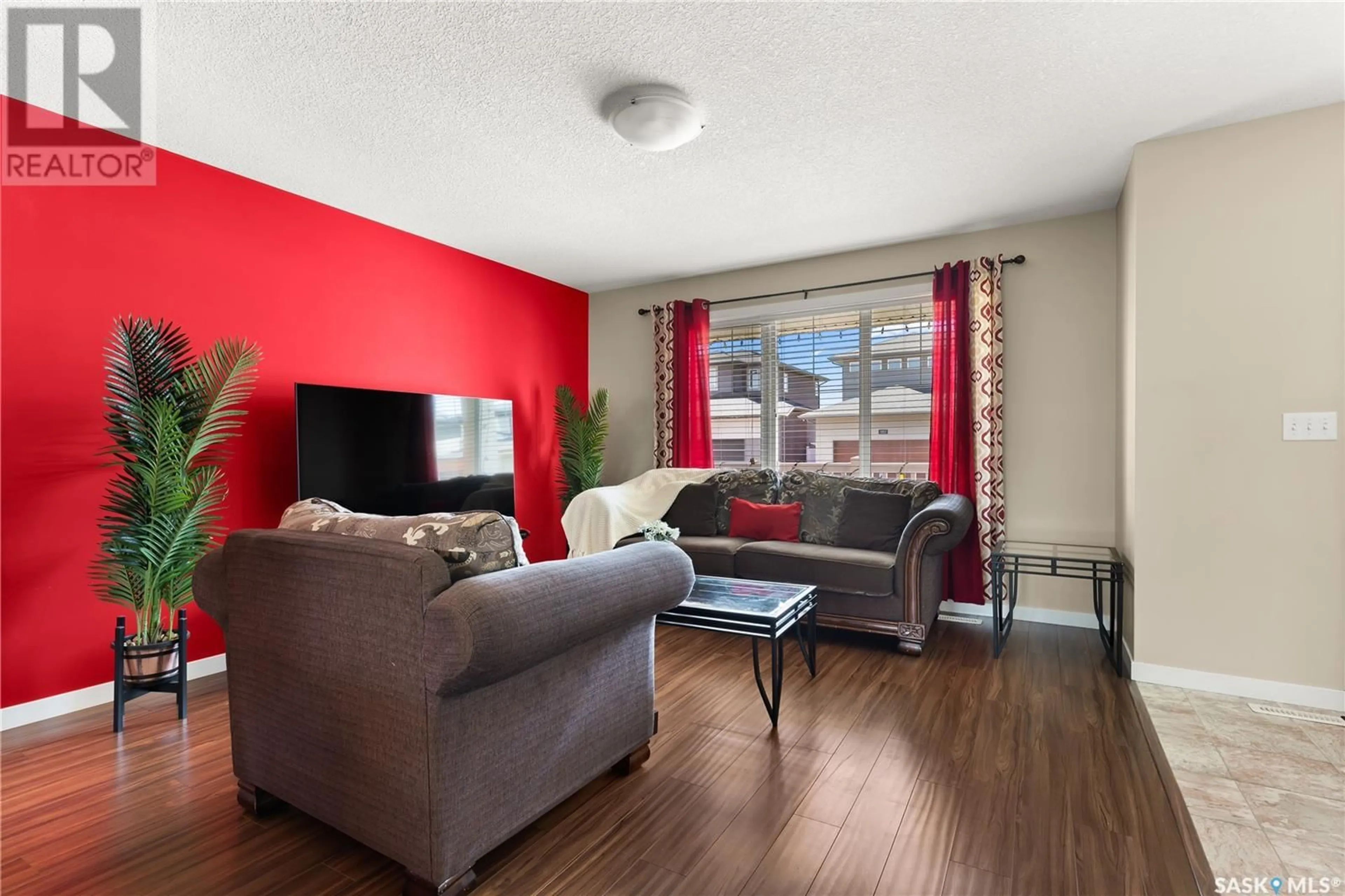 Living room with furniture, wood/laminate floor for 5017 CORNELL GATE, Regina Saskatchewan S4W0J2