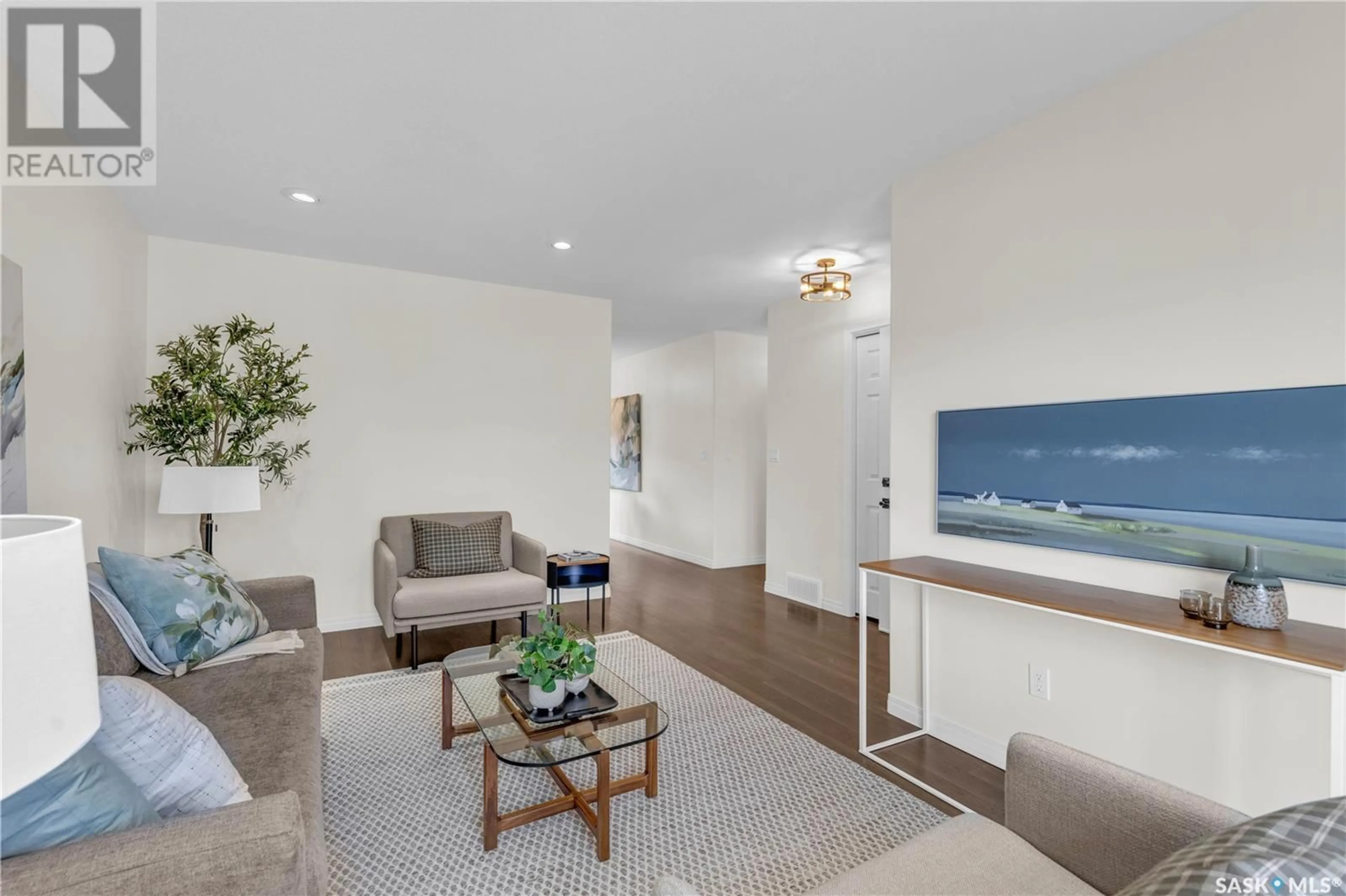 Living room with furniture, wood/laminate floor for 419 REMPEL LANE, Saskatoon Saskatchewan S7T0J3