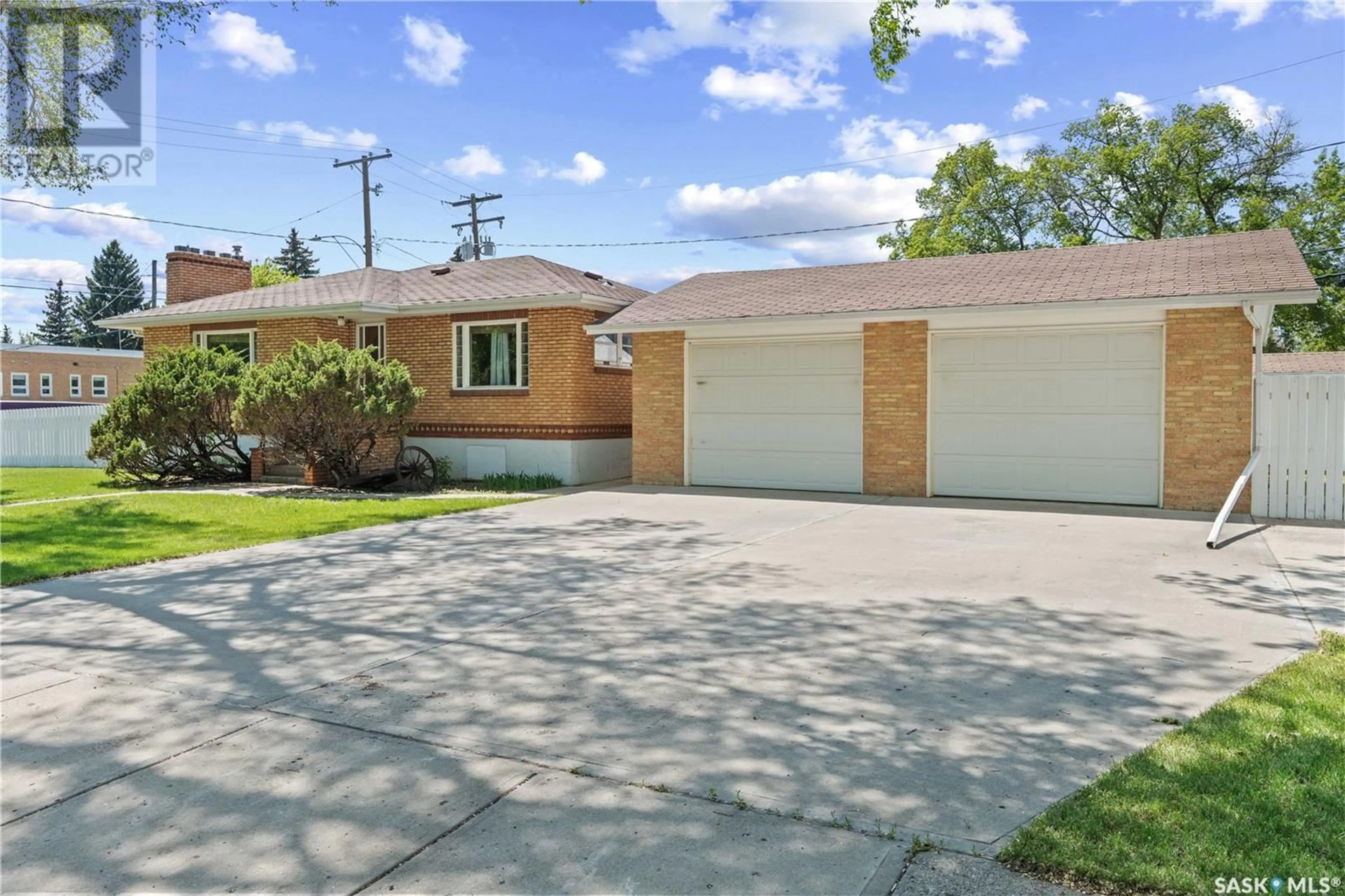 Home with brick exterior material, street for 1102 ELGIN AVENUE, Moose Jaw Saskatchewan S6H4H1