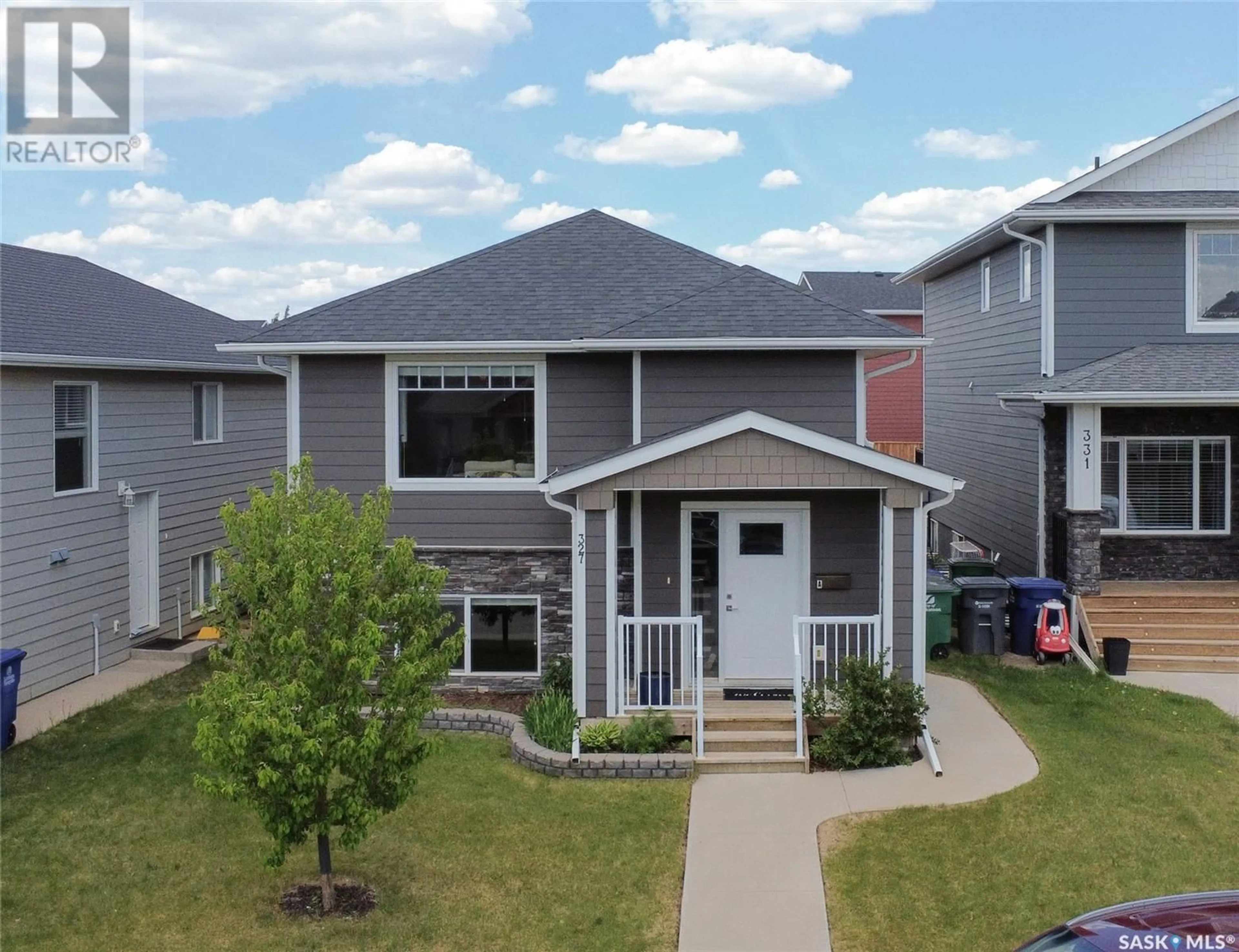 Home with vinyl exterior material, street for 327 EATON LANE, Saskatoon Saskatchewan S7V0H5
