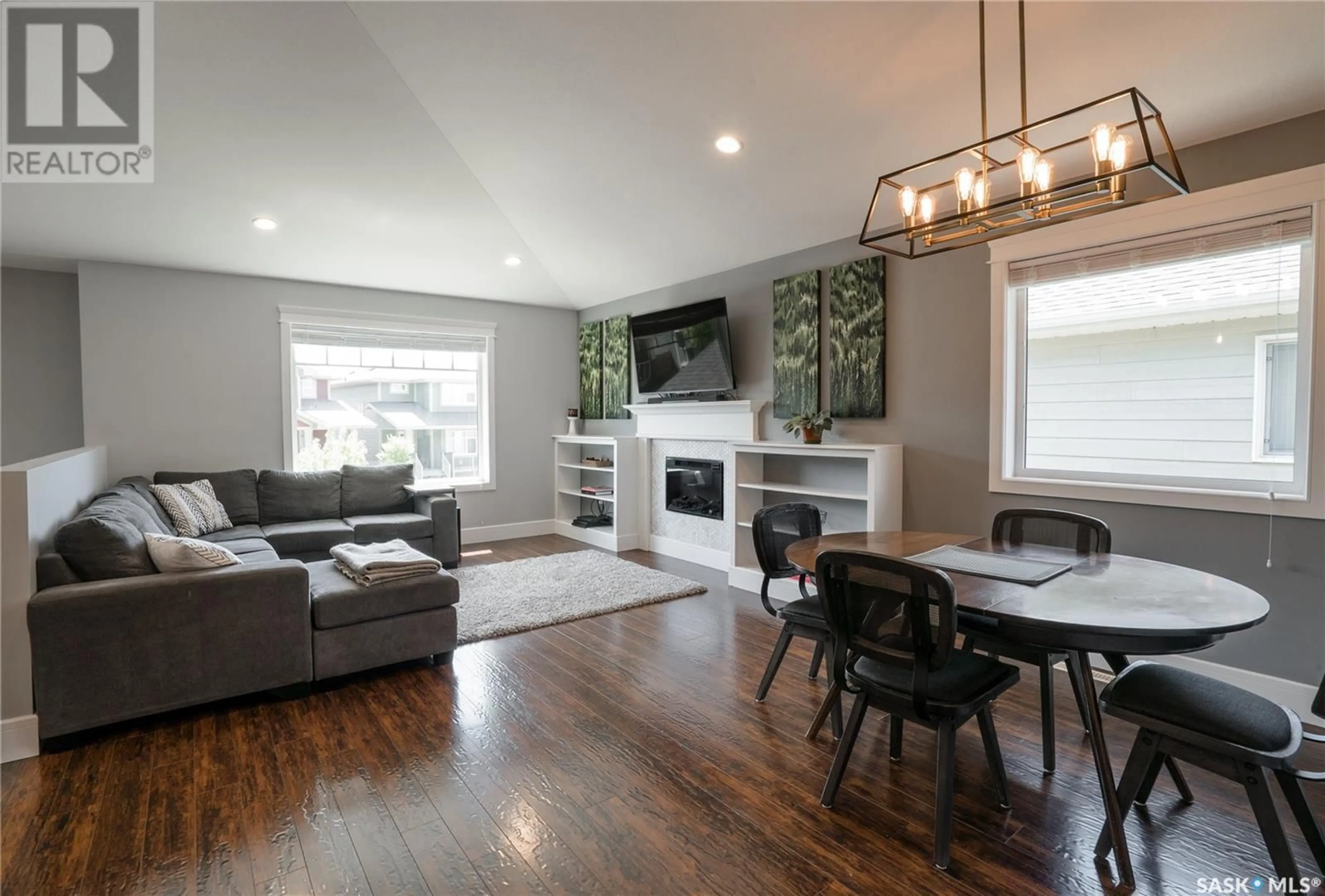 Living room with furniture, wood/laminate floor for 327 EATON LANE, Saskatoon Saskatchewan S7V0H5