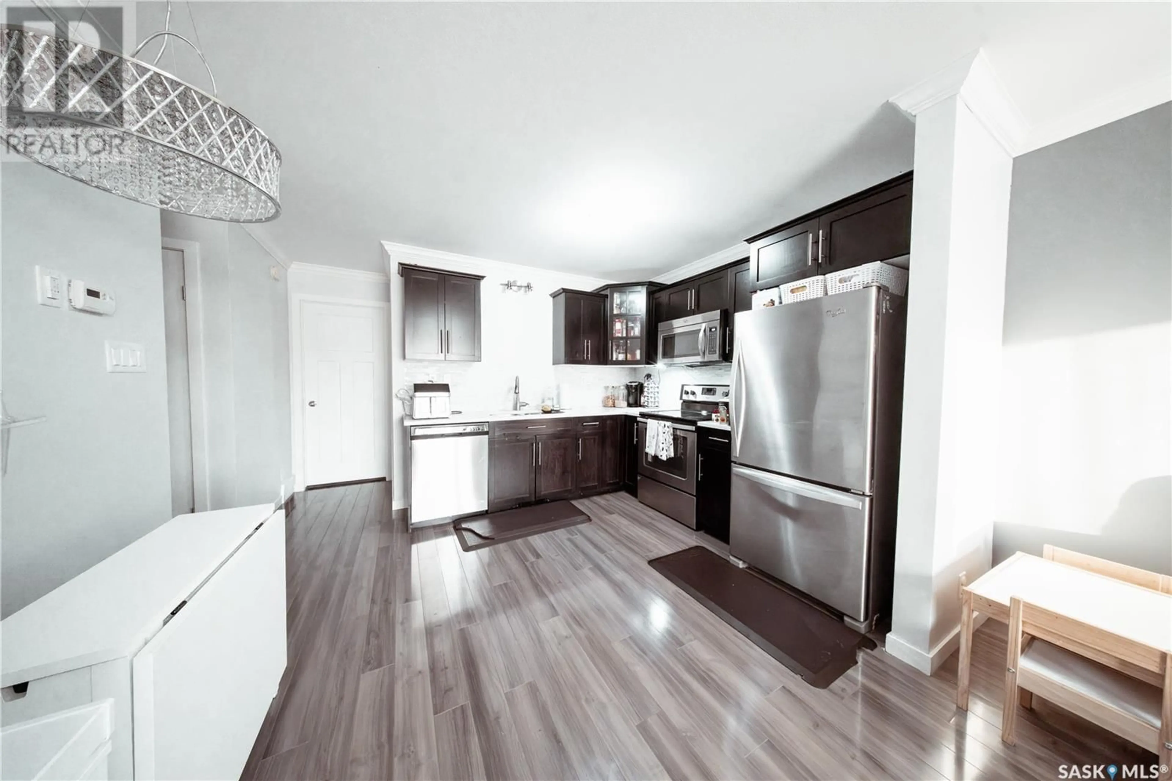 Open concept kitchen, wood/laminate floor for 331 620 CORNISH ROAD, Saskatoon Saskatchewan S7T0Y3