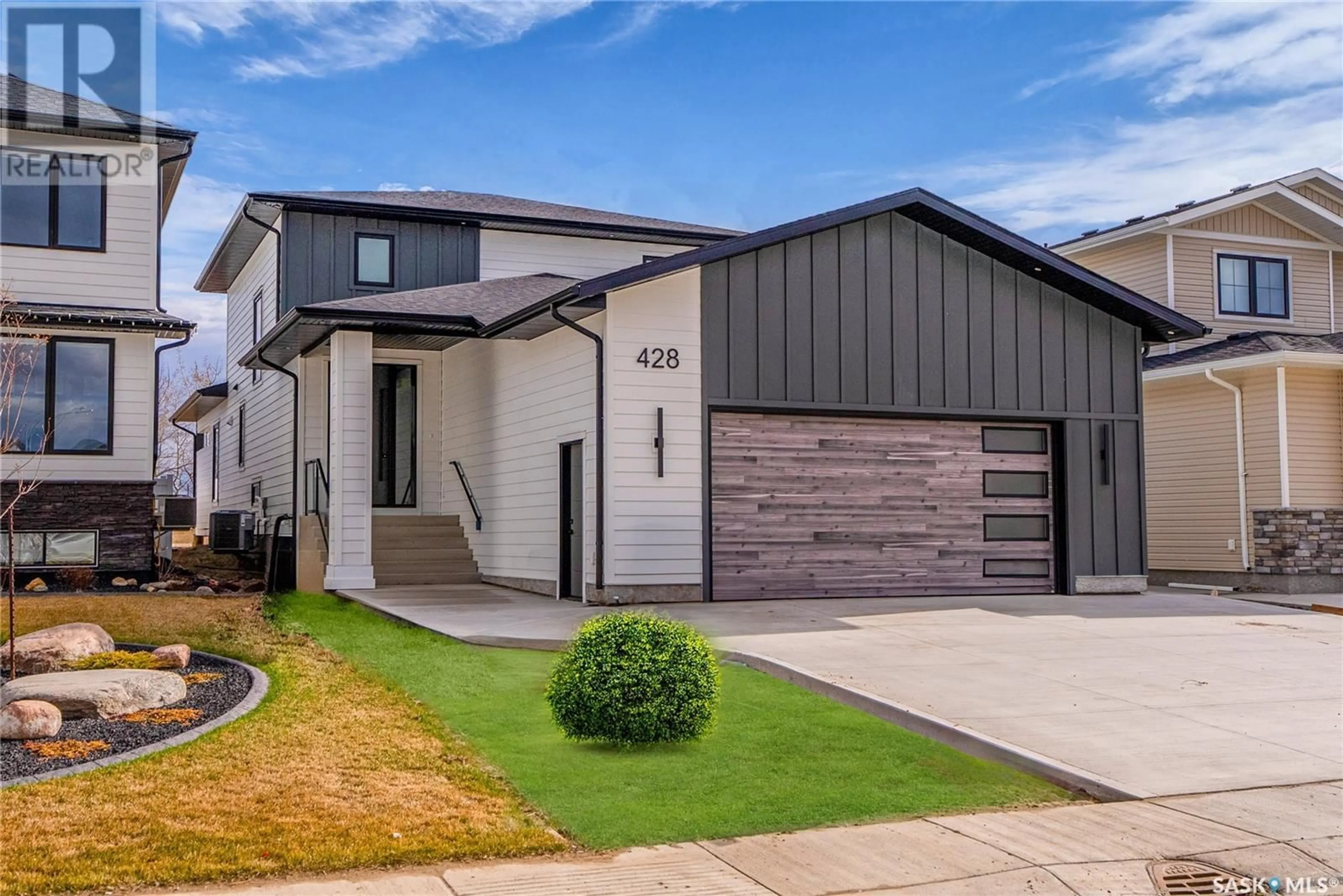 Home with vinyl exterior material, street for 428 WOOLF BEND, Saskatoon Saskatchewan S7W1E5