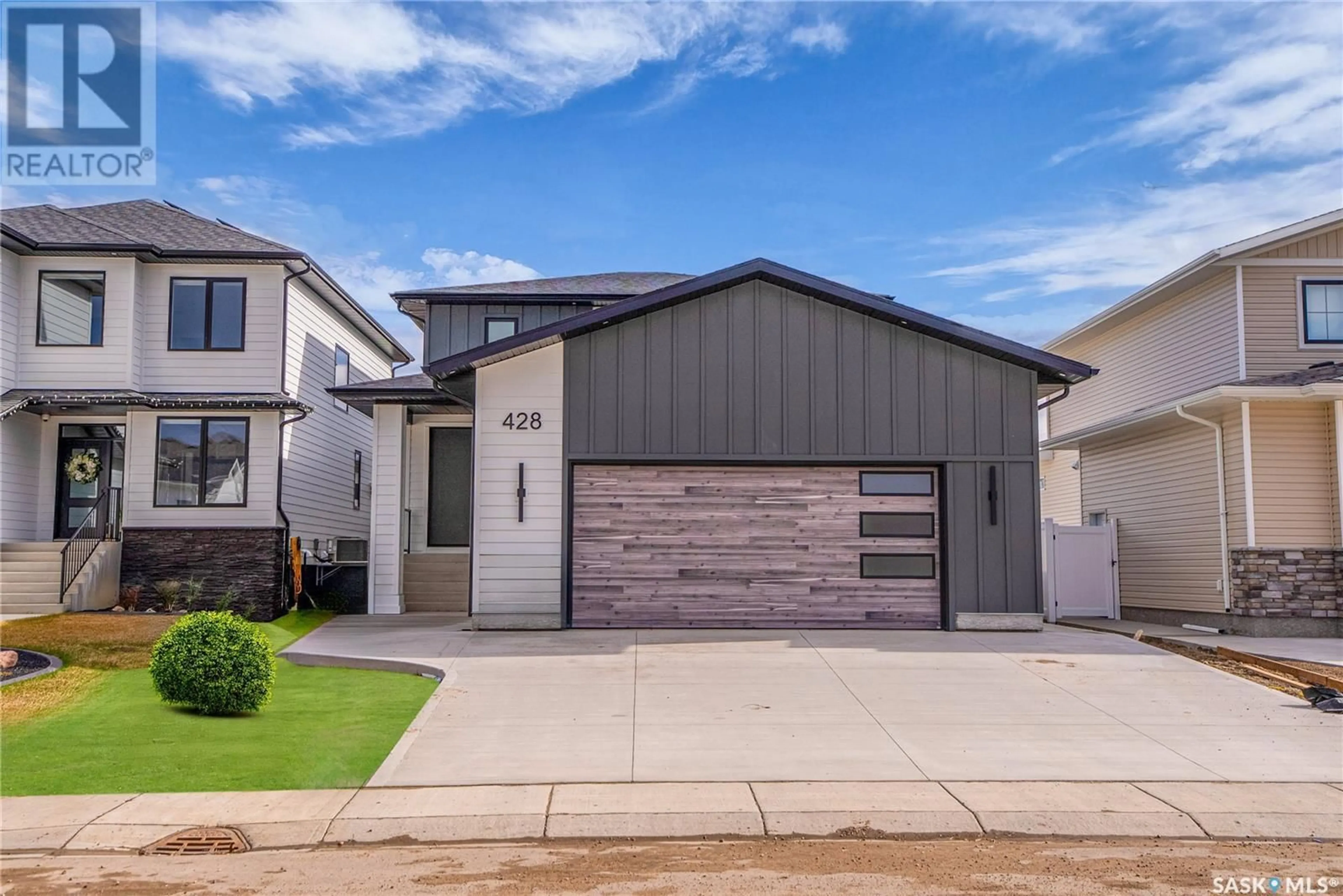 Home with vinyl exterior material, street for 428 WOOLF BEND, Saskatoon Saskatchewan S7W1E5