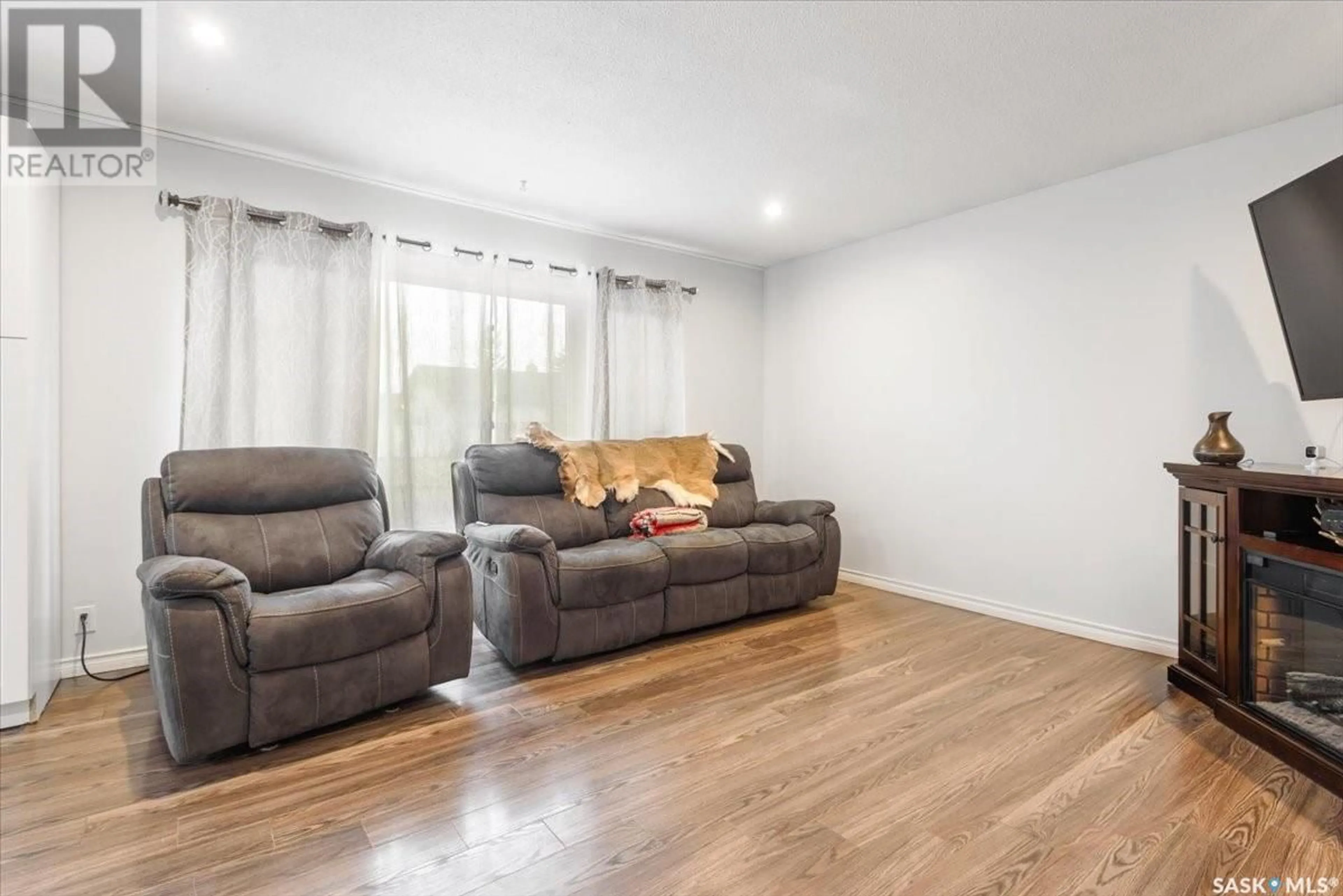 Living room with furniture, wood/laminate floor for 345 FORGET STREET, Regina Saskatchewan S4R4X7