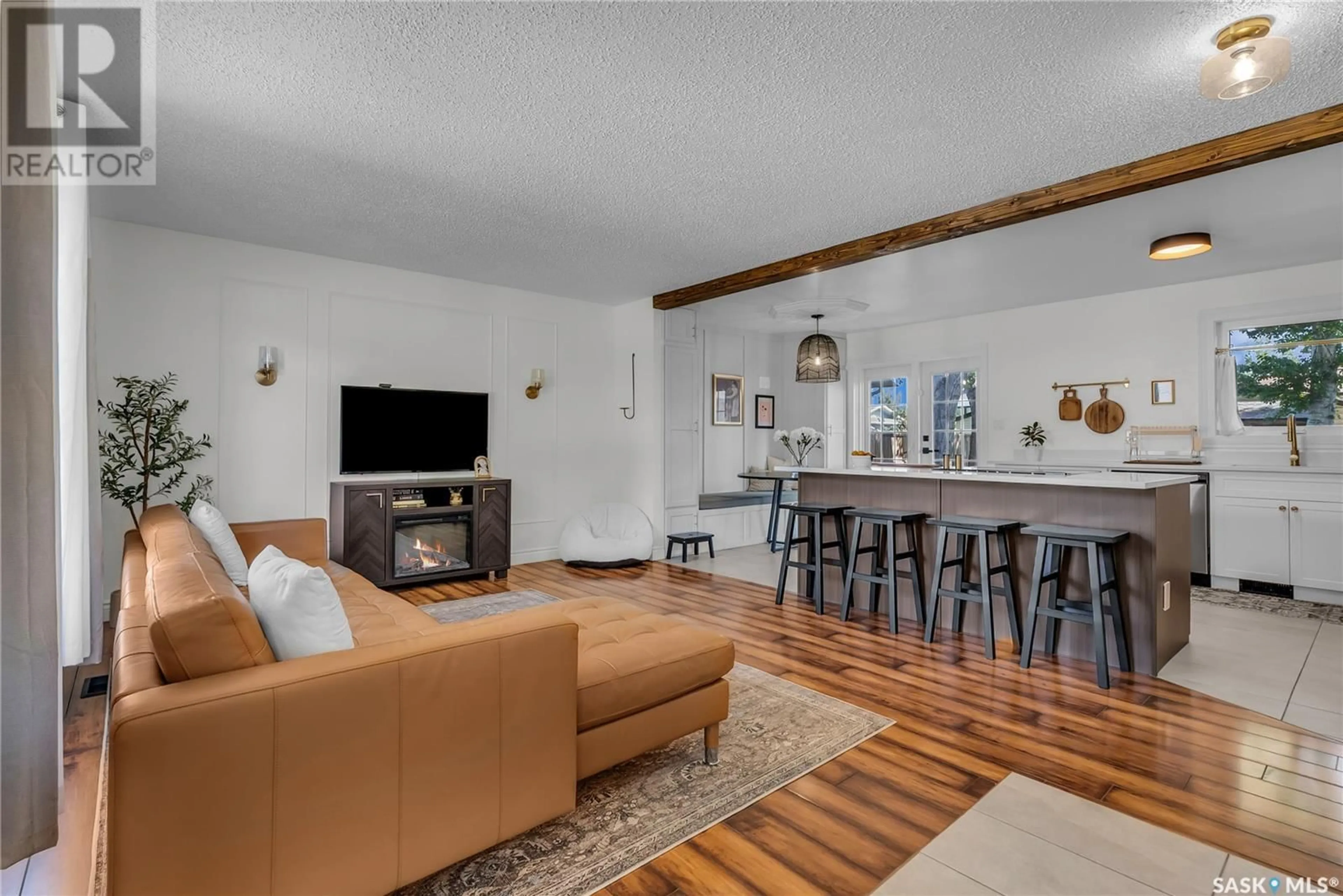 Living room with furniture, wood/laminate floor for 110 WAKABAYASHI CRESCENT, Saskatoon Saskatchewan S7K7L8