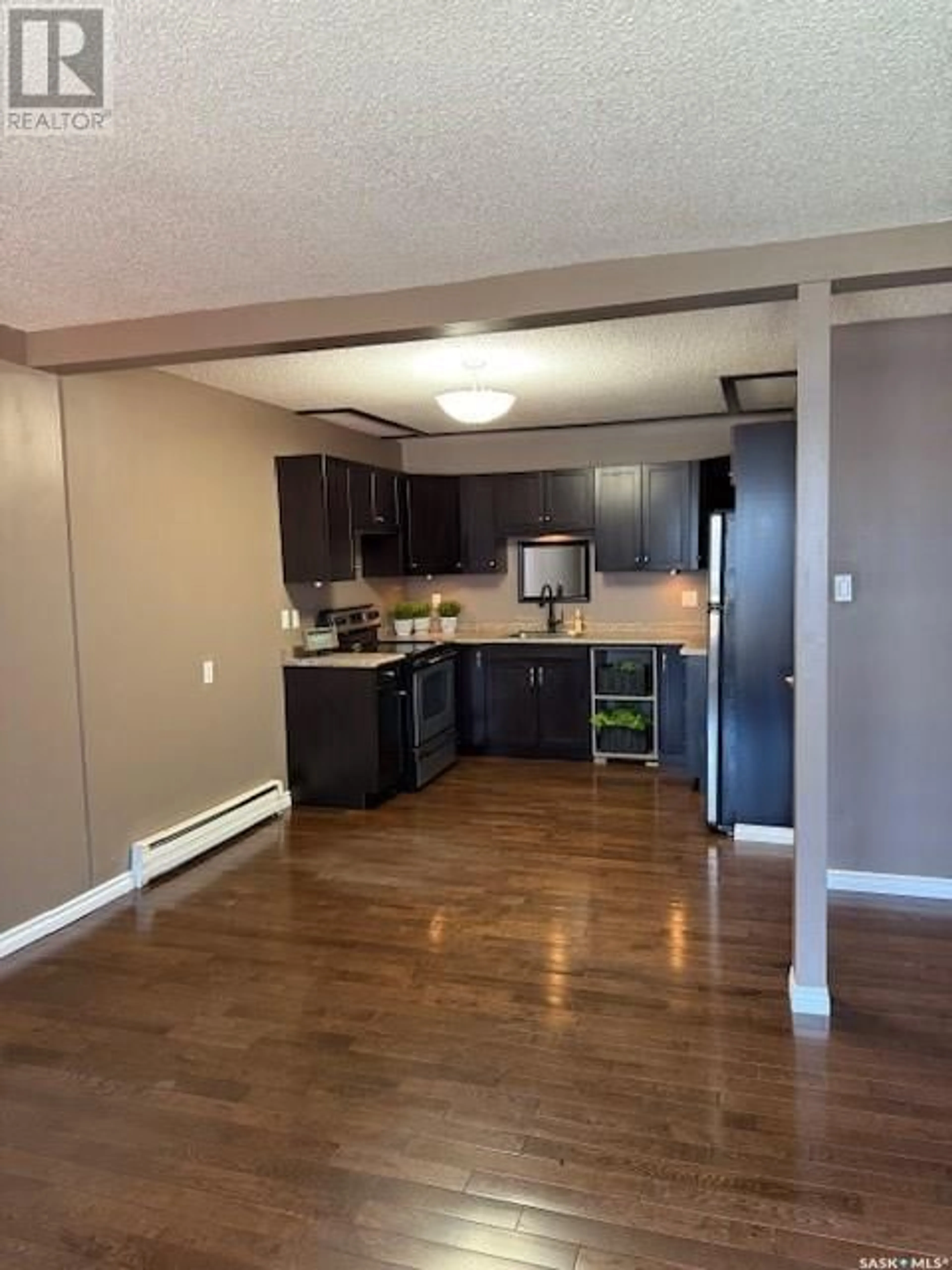 Open concept kitchen, wood/laminate floor for 38 - 22 SPENCE STREET, Regina Saskatchewan S4S4H4