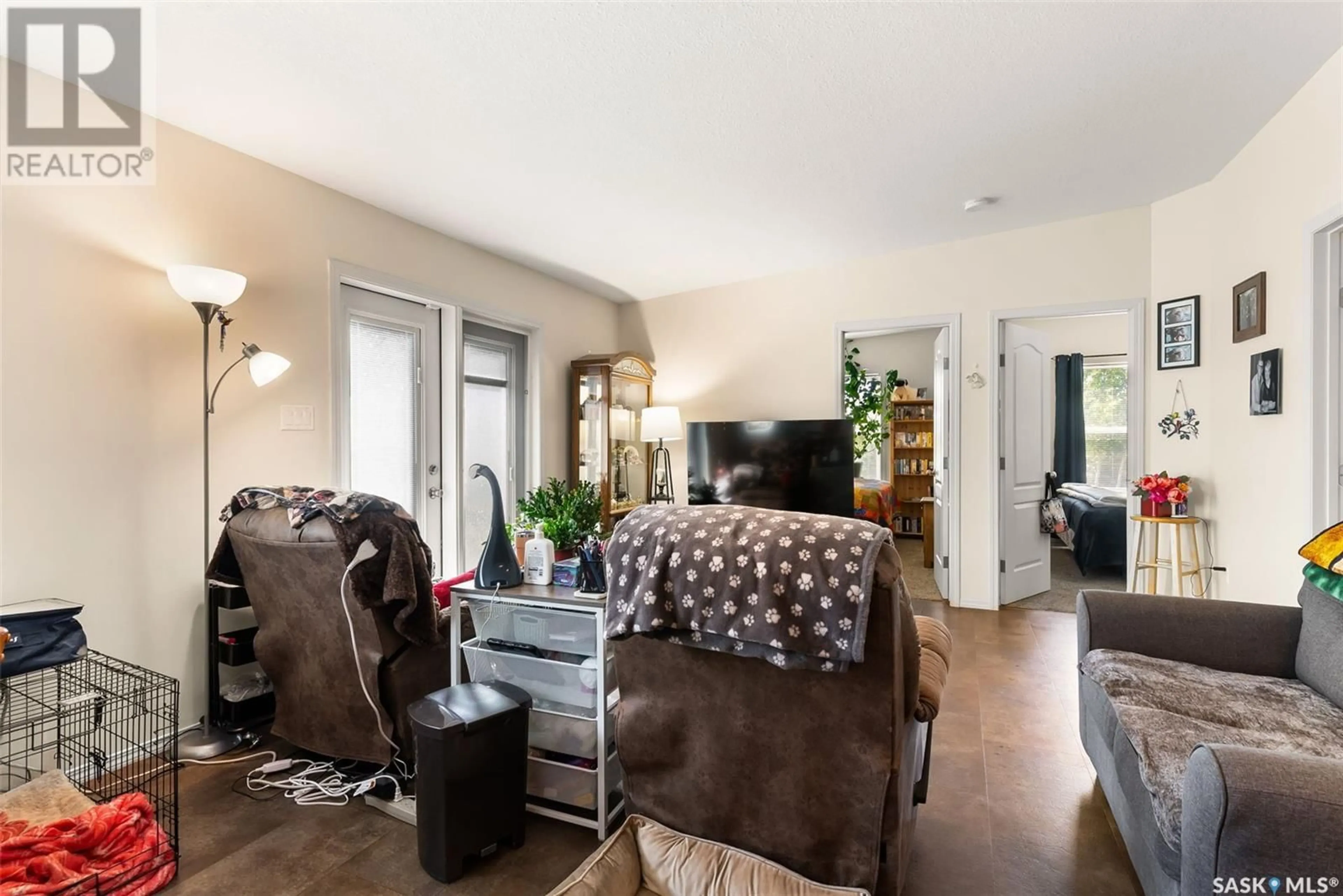 Living room with furniture, wood/laminate floor for 195 CHATEAU CRESCENT, Pilot Butte Saskatchewan S0G3Z0