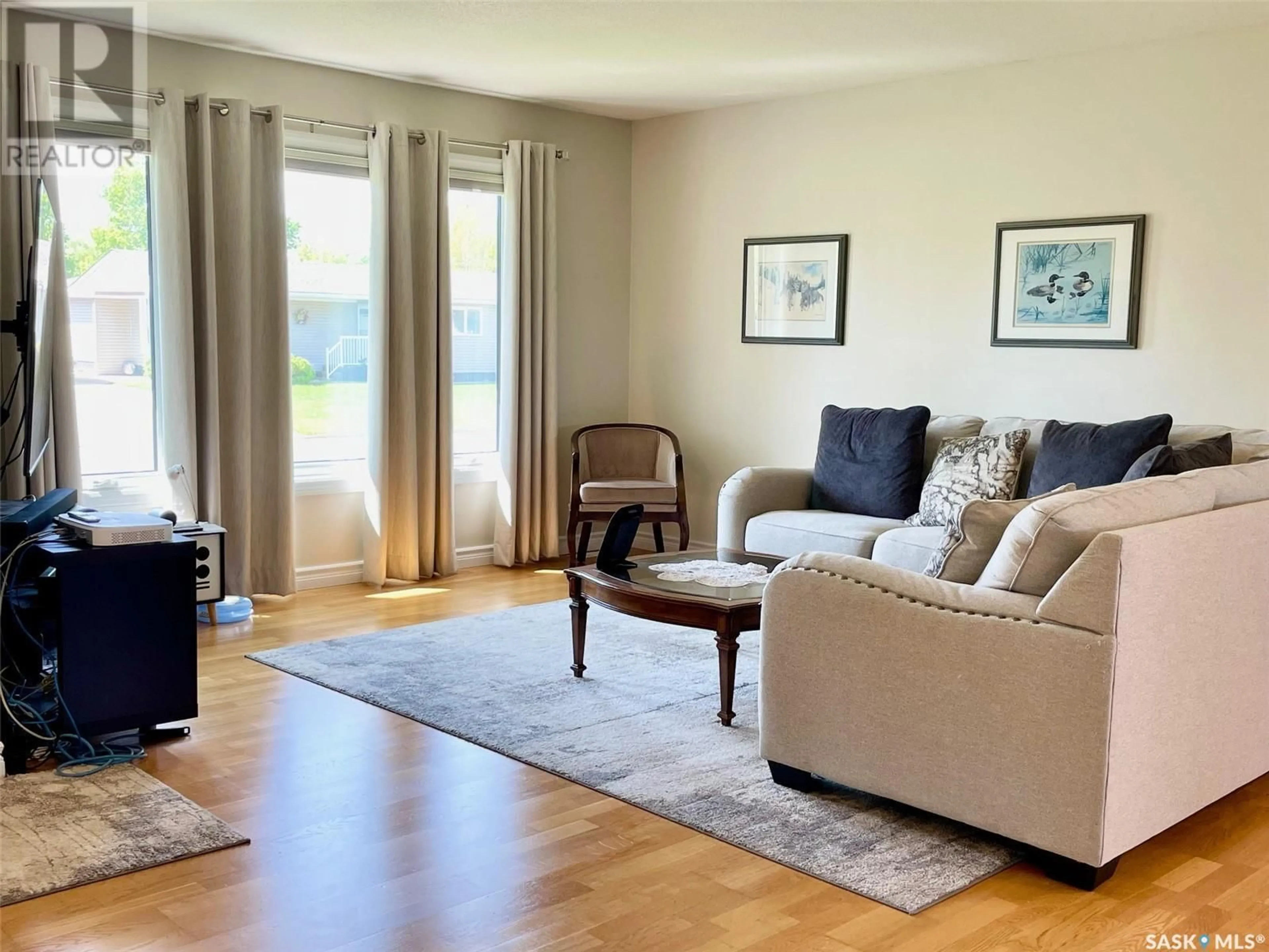Living room with furniture, wood/laminate floor for 536 ALBERTA STREET, Melville Saskatchewan S0A2P0