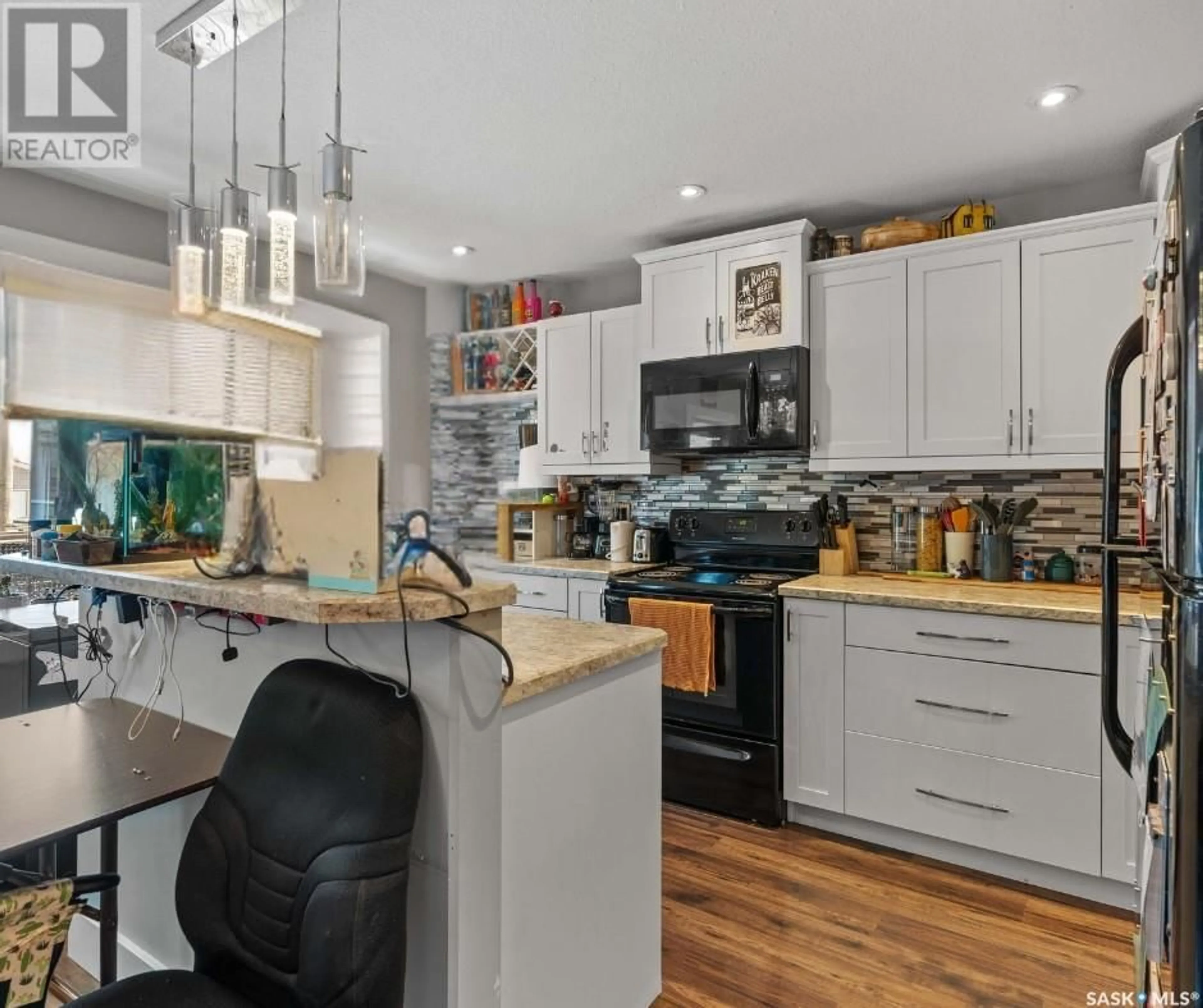 Open concept kitchen, wood/laminate floor for 1545 LACON STREET, Regina Saskatchewan S4N1Z3