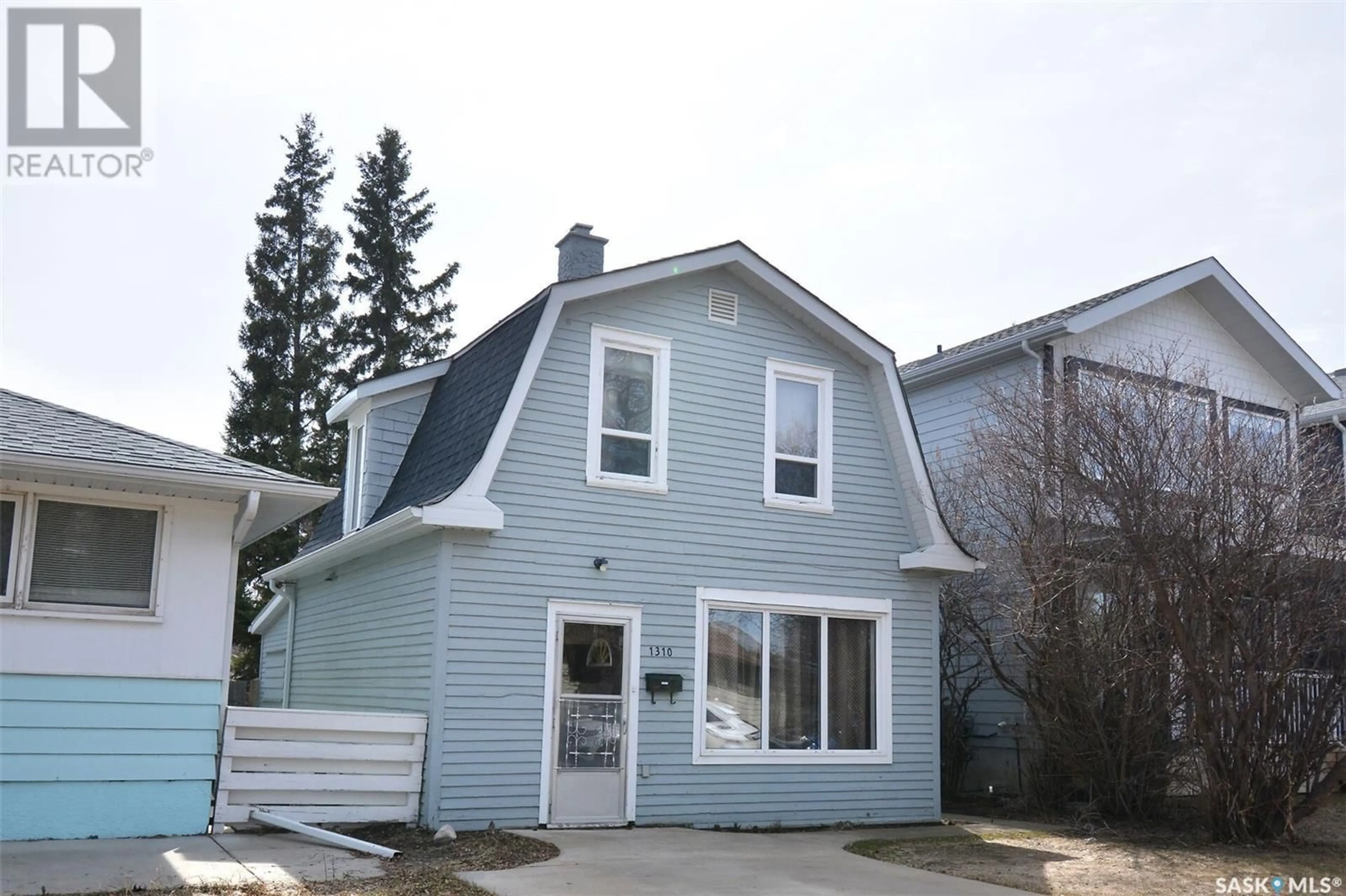 Home with vinyl exterior material, street for 1310 13TH STREET, Saskatoon Saskatchewan S7H0C6