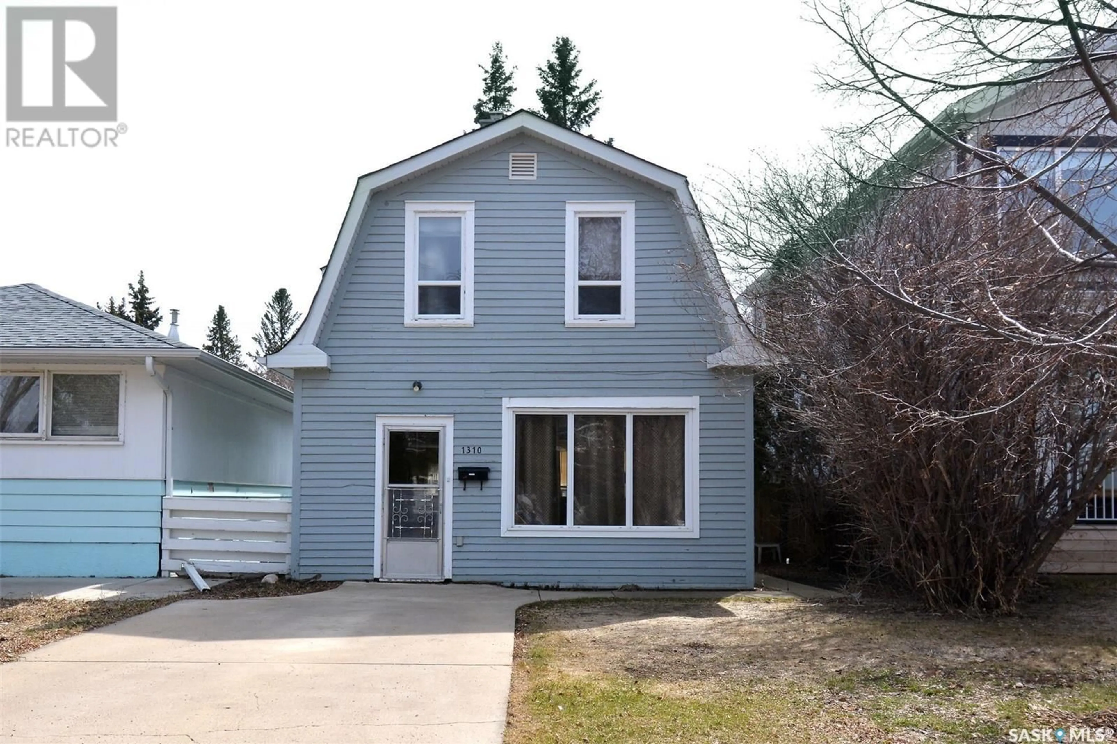 Home with vinyl exterior material, street for 1310 13TH STREET, Saskatoon Saskatchewan S7H0C6