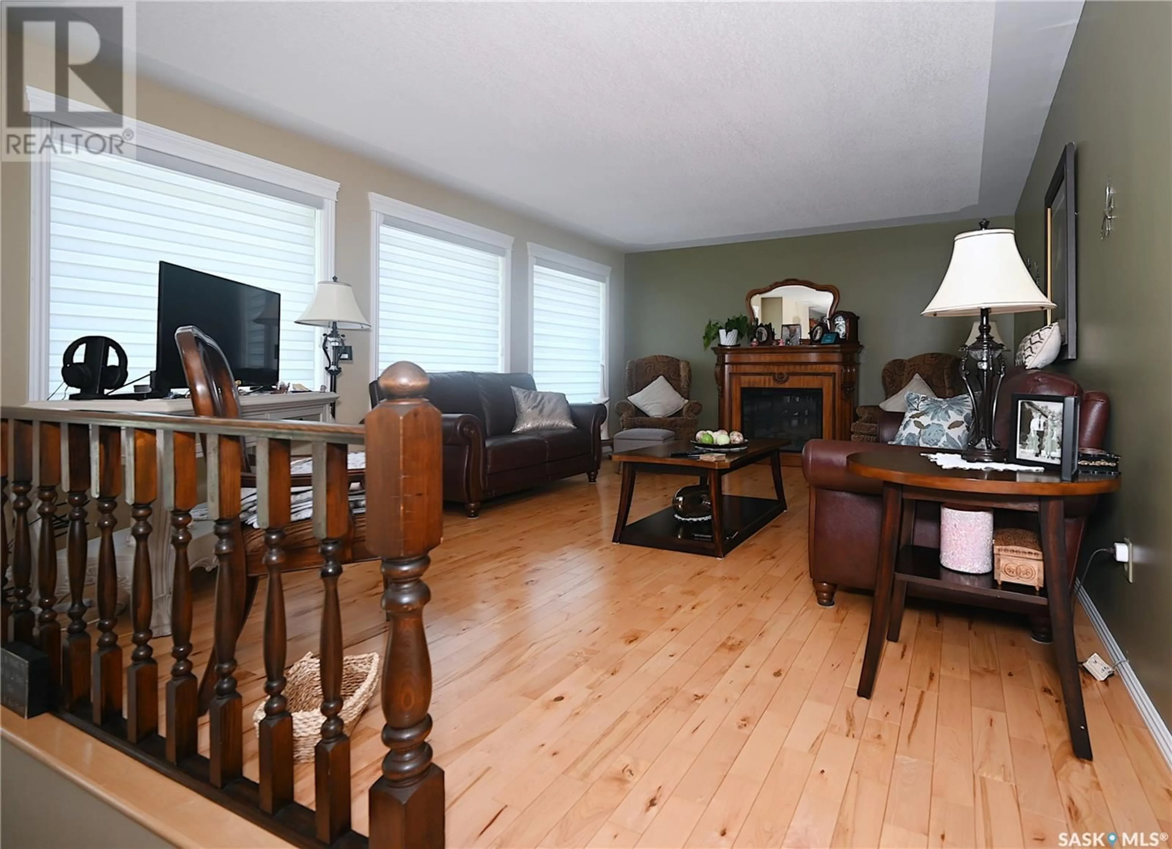 Living room with furniture, wood/laminate floor for 1291 VETERANS AVENUE, Estevan Saskatchewan S4A1Z8