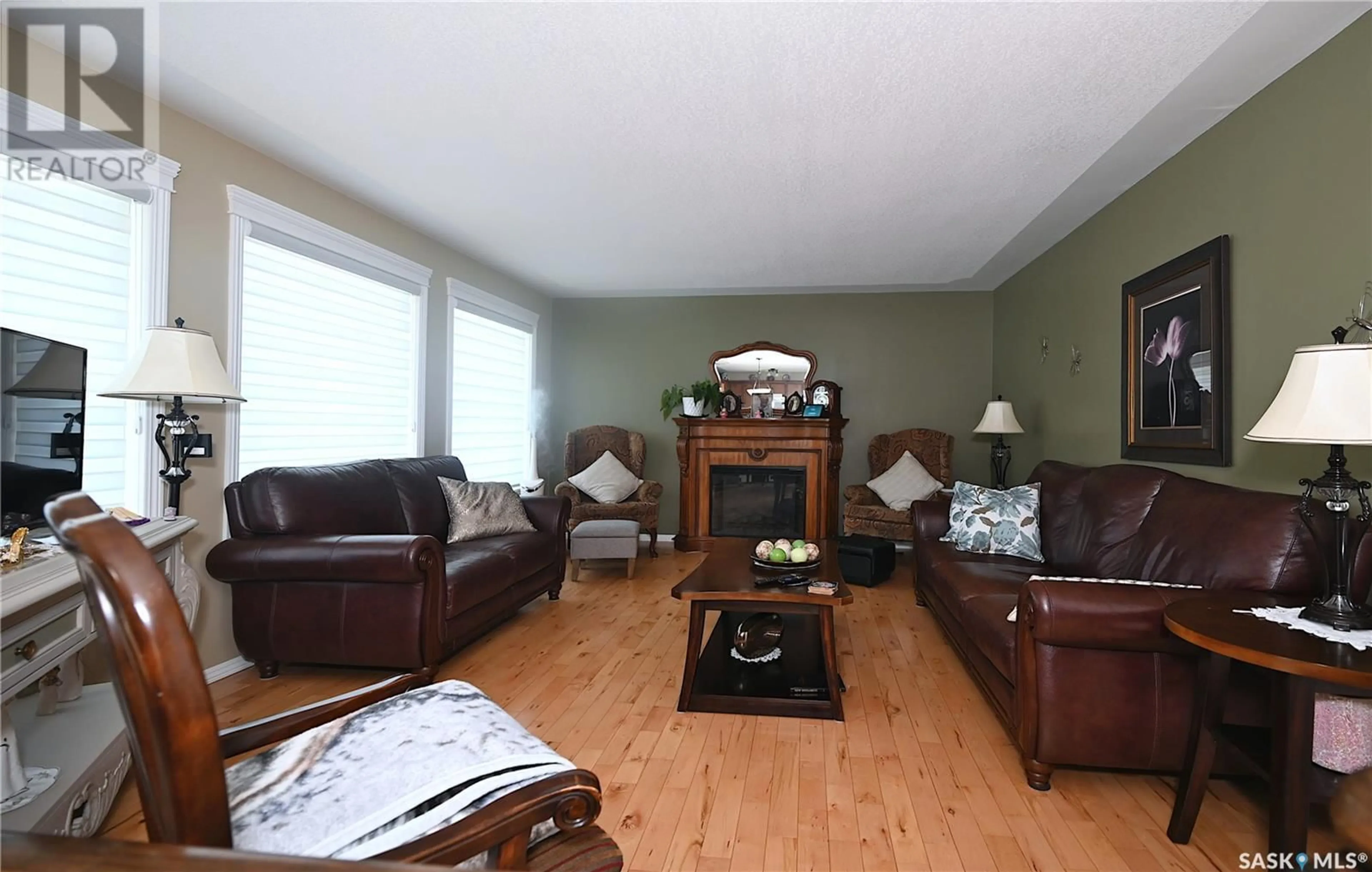 Living room with furniture, wood/laminate floor for 1291 VETERANS AVENUE, Estevan Saskatchewan S4A1Z8