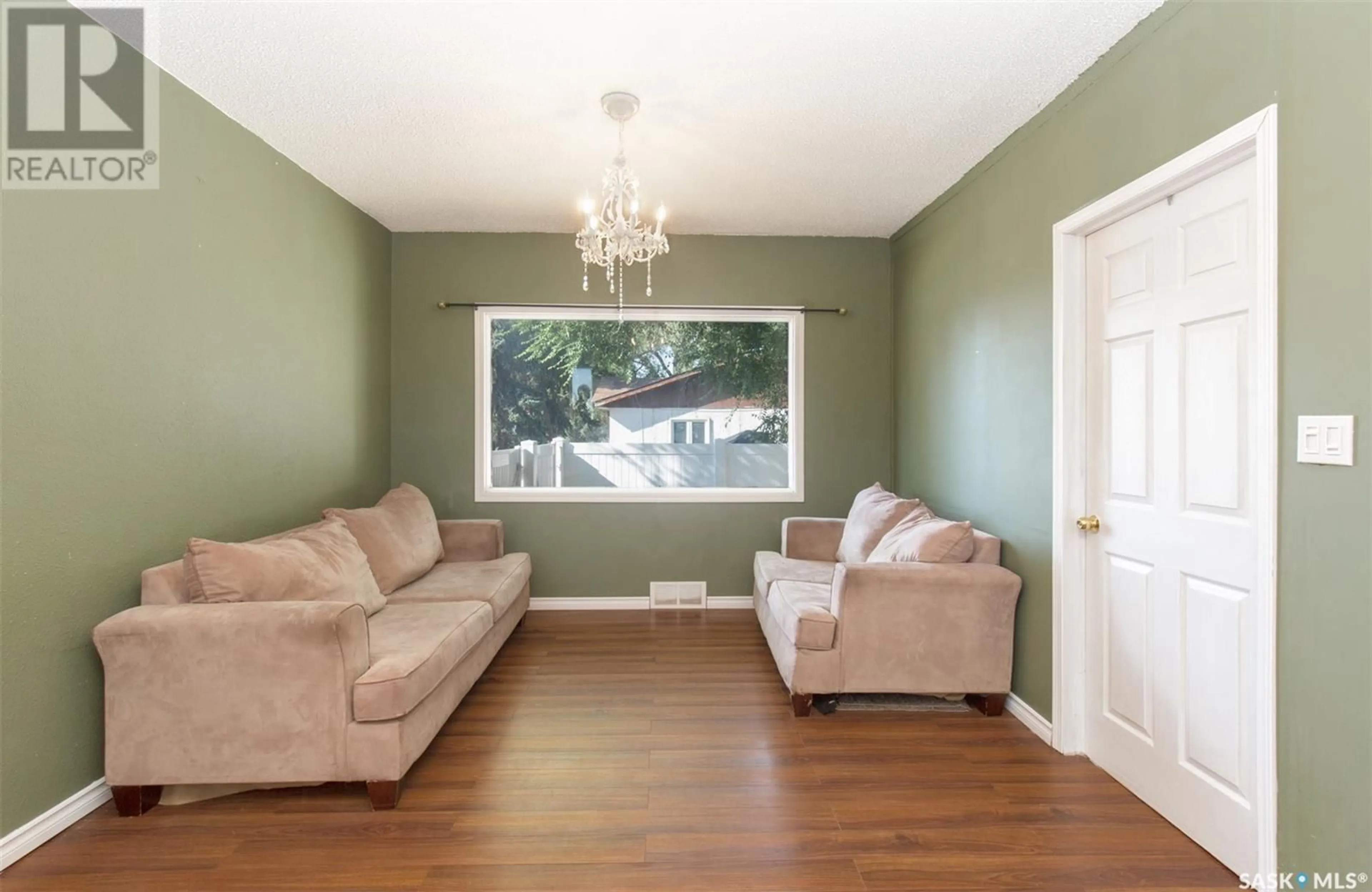 Living room with furniture, wood/laminate floor for 1109 9TH AVENUE, Moose Jaw Saskatchewan S6H4J8