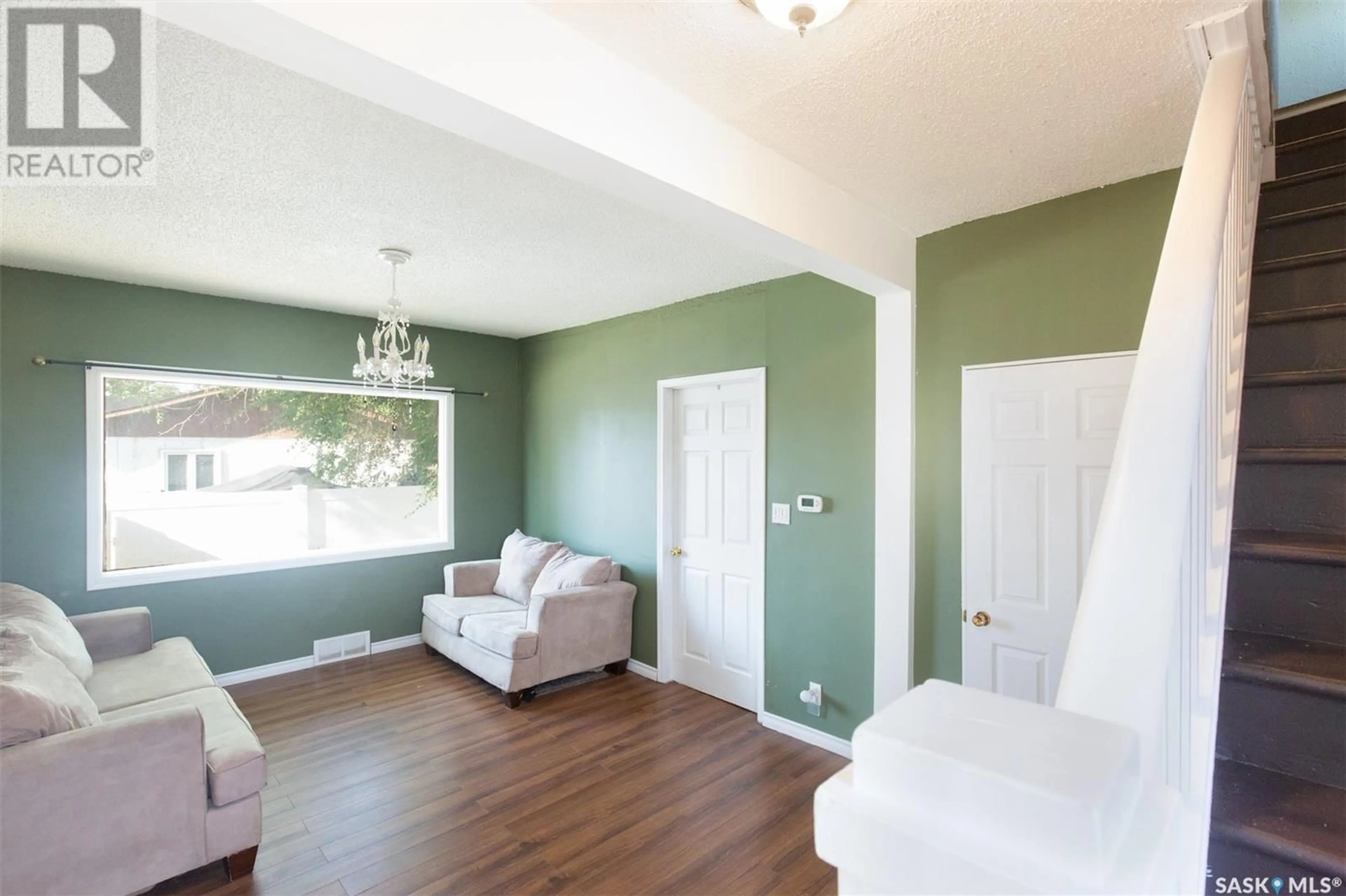 Living room with furniture, wood/laminate floor for 1109 9TH AVENUE, Moose Jaw Saskatchewan S6H4J8