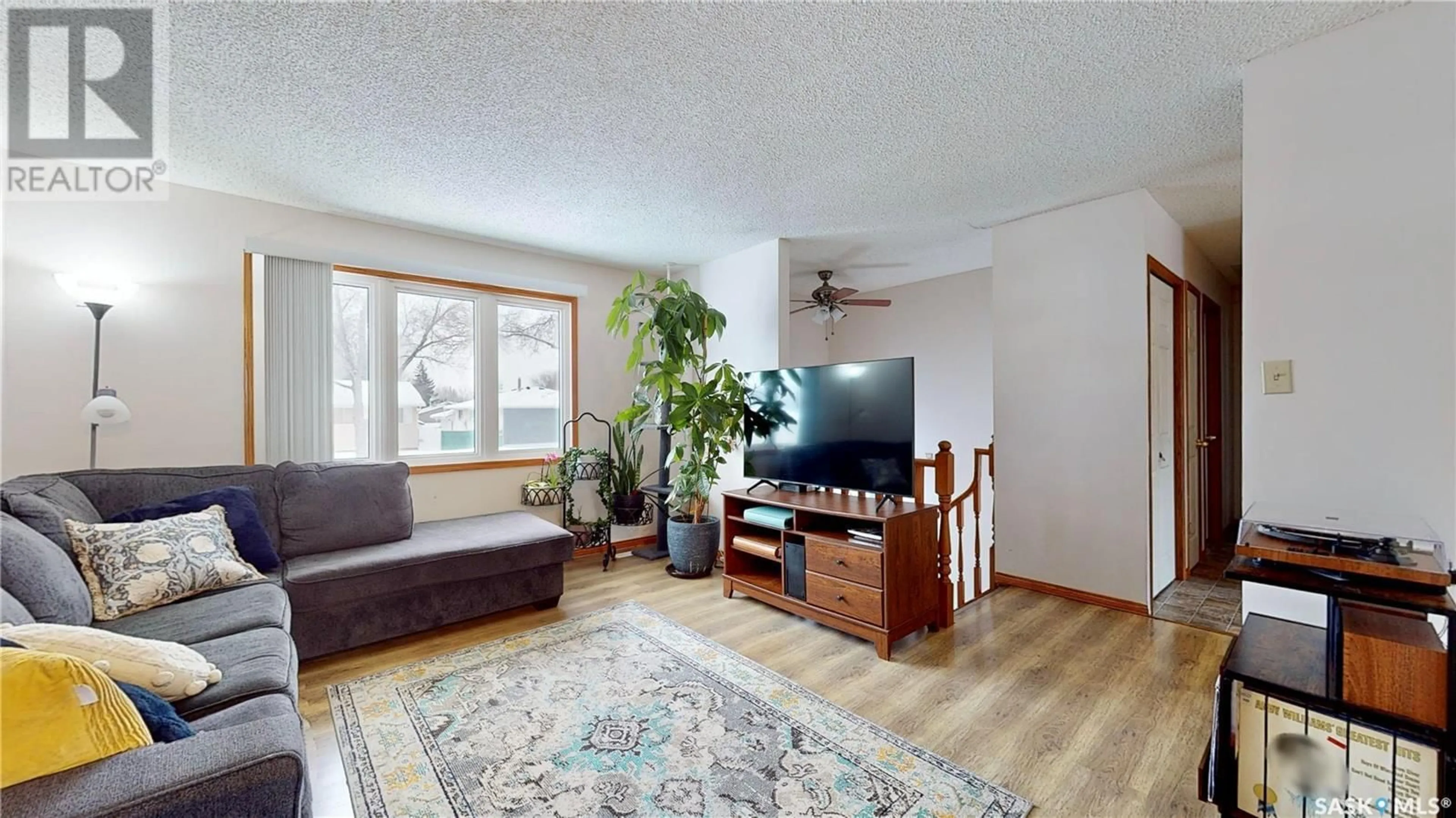 Living room with furniture, wood/laminate floor for 384 CAVENDISH STREET, Regina Saskatchewan S4N4K2