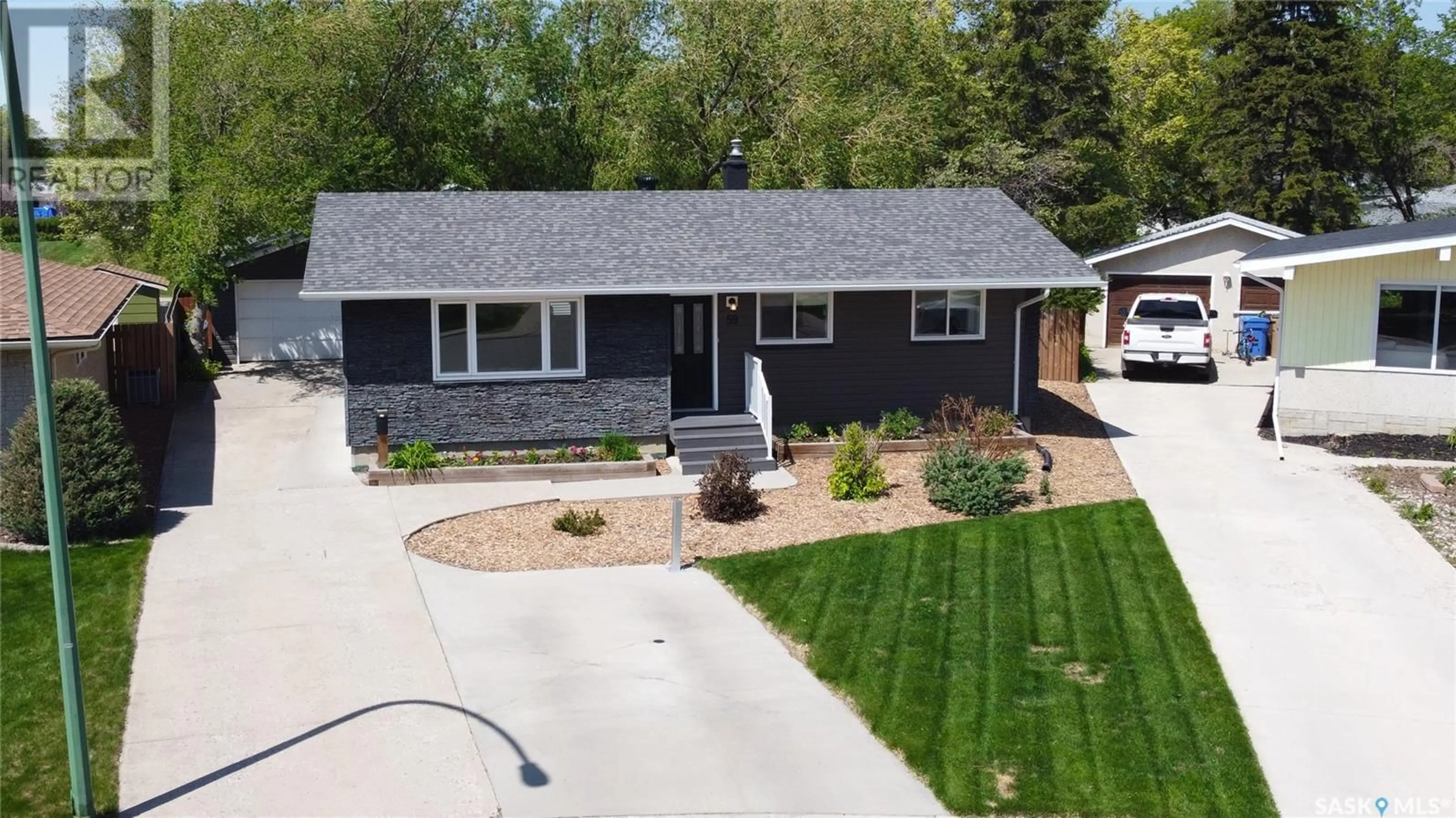 Home with vinyl exterior material, street for 59 WILSON CRESCENT, Regina Saskatchewan S4R5B2