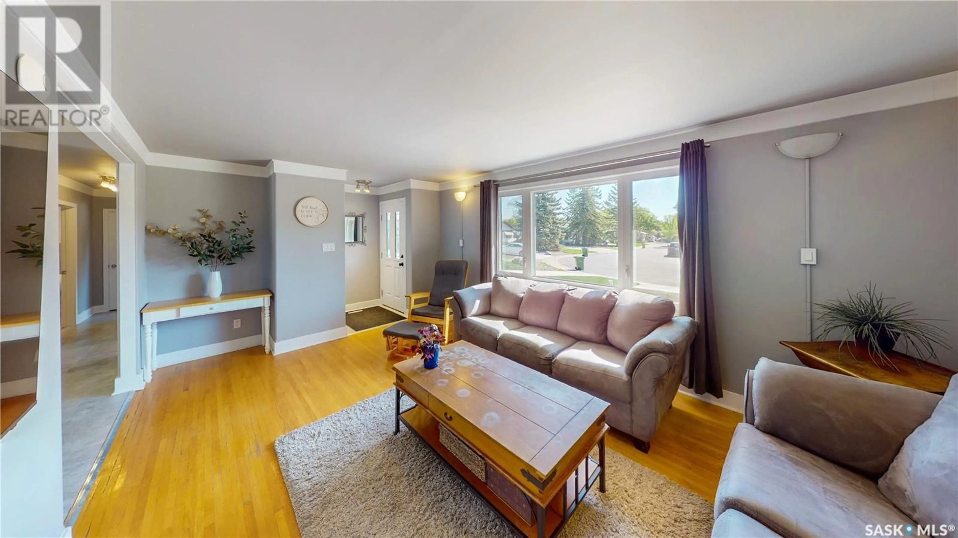 Living room with furniture, wood/laminate floor for 59 WILSON CRESCENT, Regina Saskatchewan S4R5B2