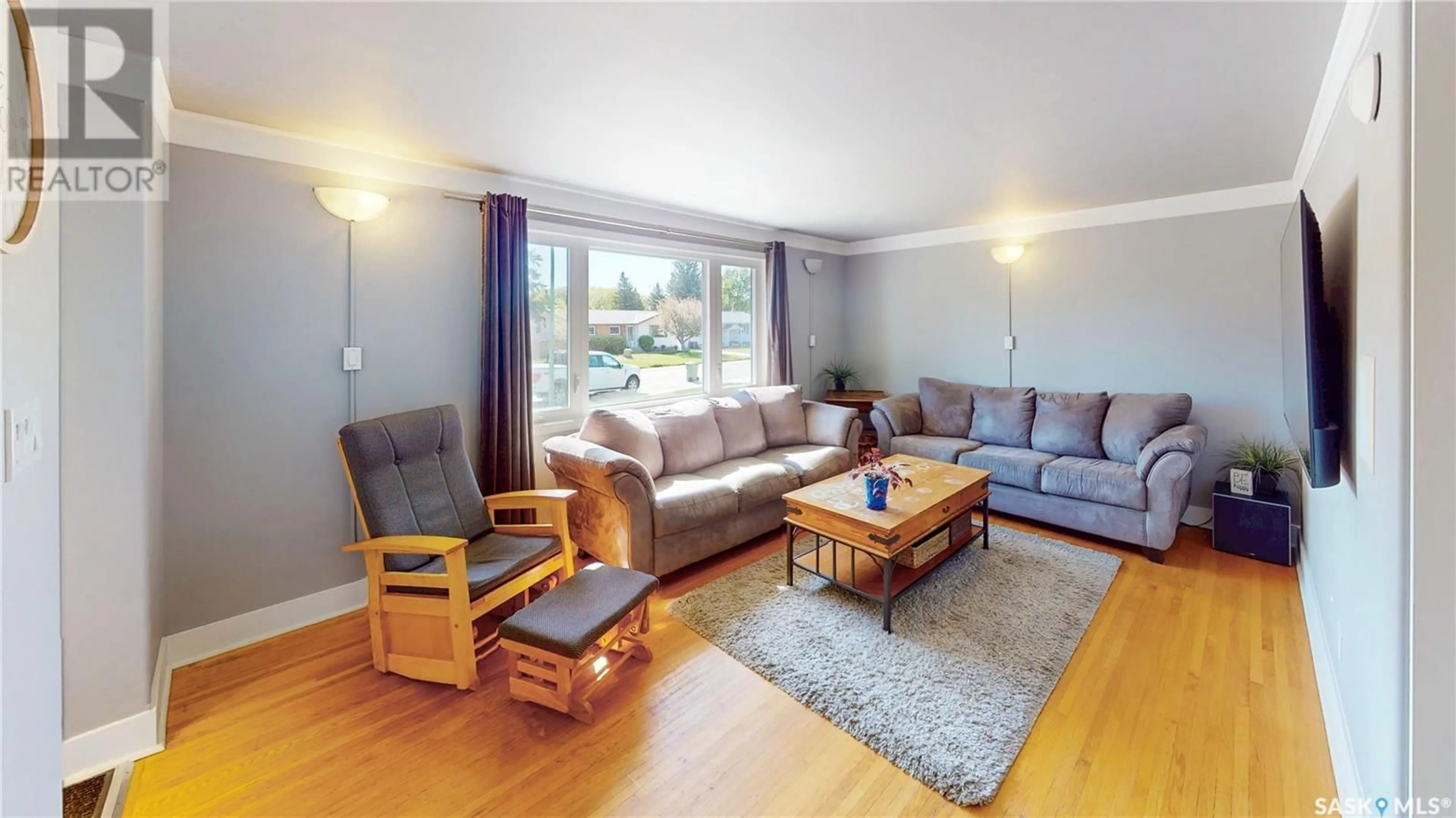 Living room with furniture, wood/laminate floor for 59 WILSON CRESCENT, Regina Saskatchewan S4R5B2