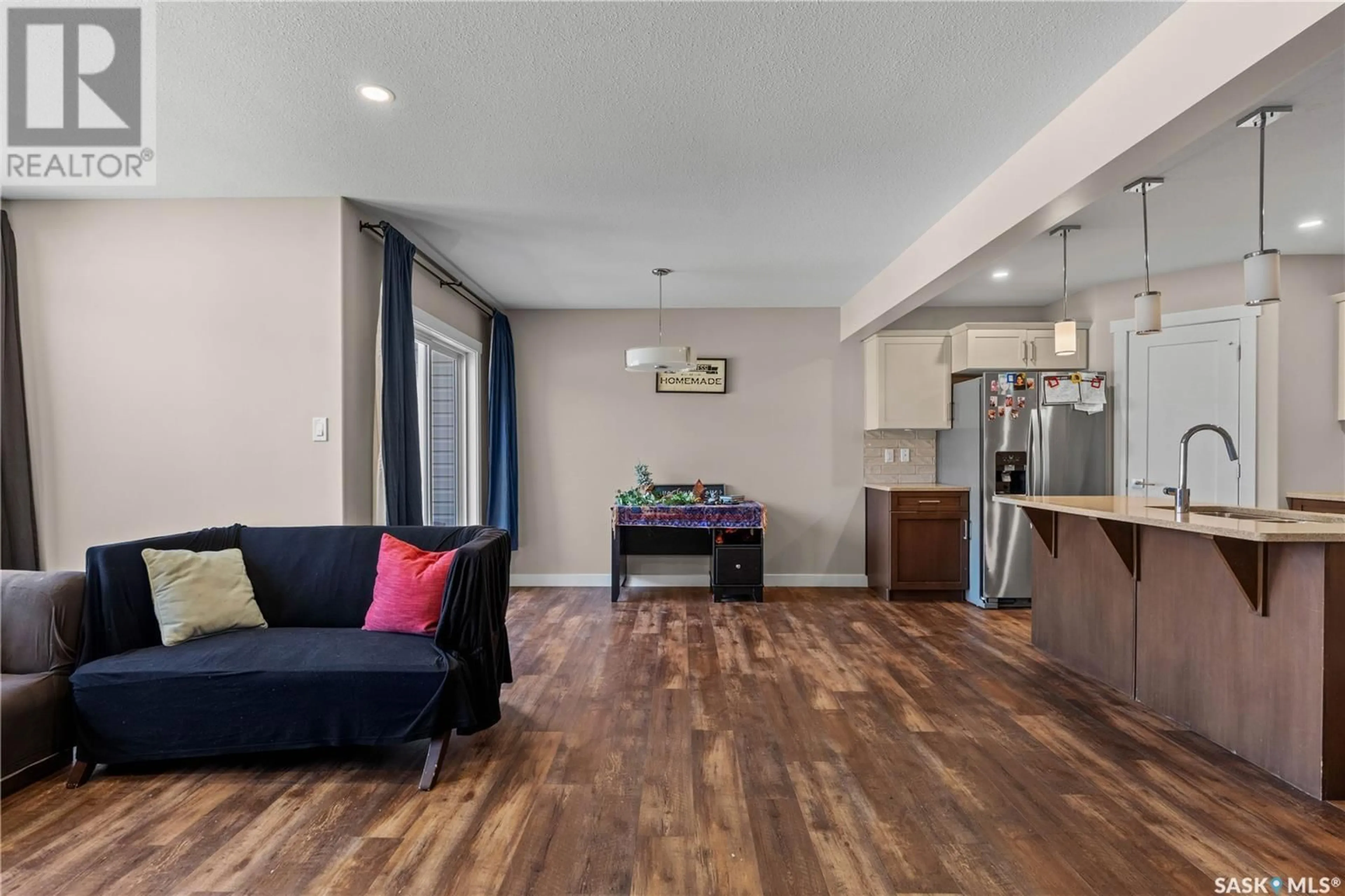 Living room with furniture, wood/laminate floor for 3250 GREEN STONE ROAD, Regina Saskatchewan S4V3R2