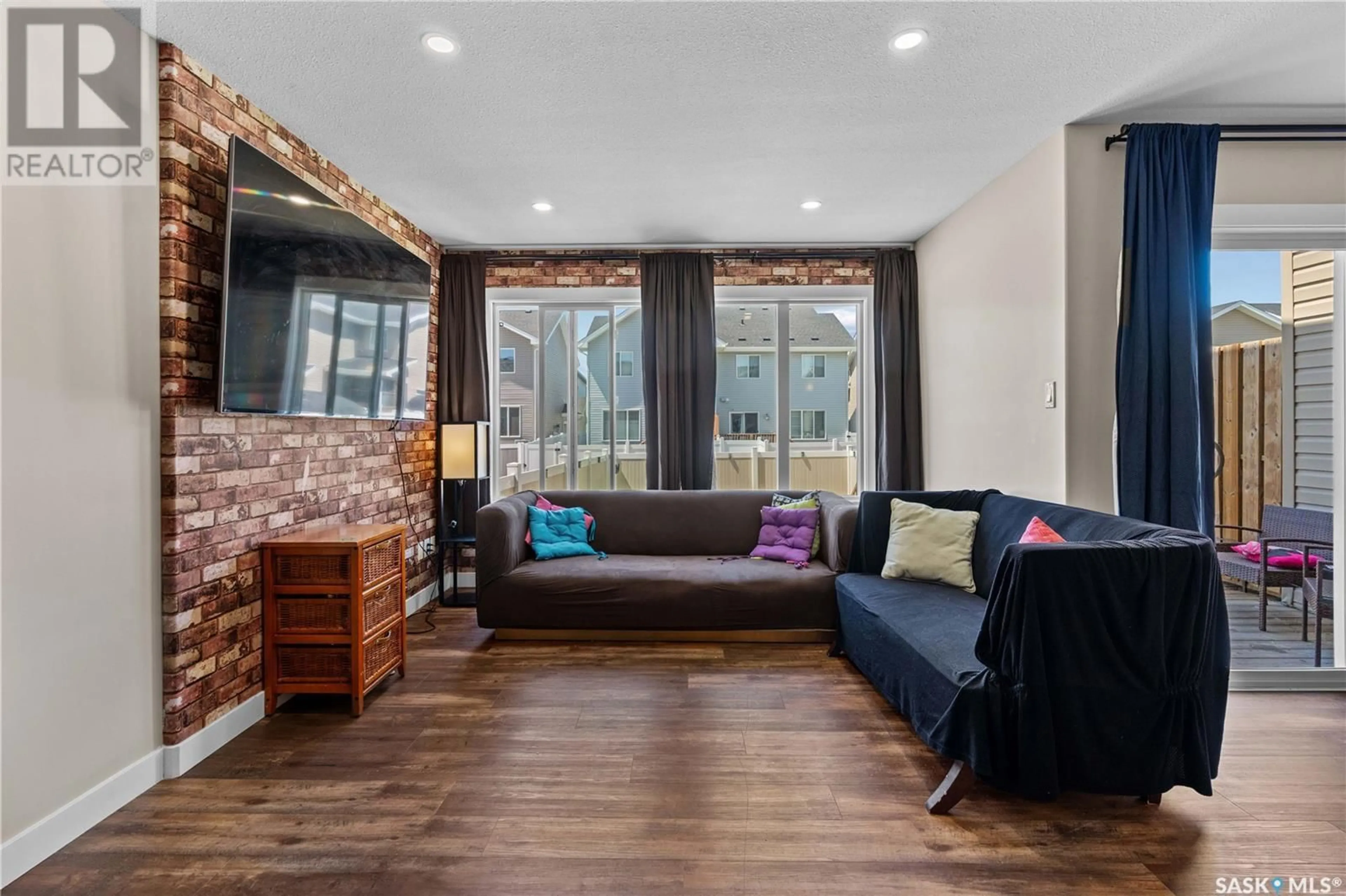 Living room with furniture, wood/laminate floor for 3250 GREEN STONE ROAD, Regina Saskatchewan S4V3R2