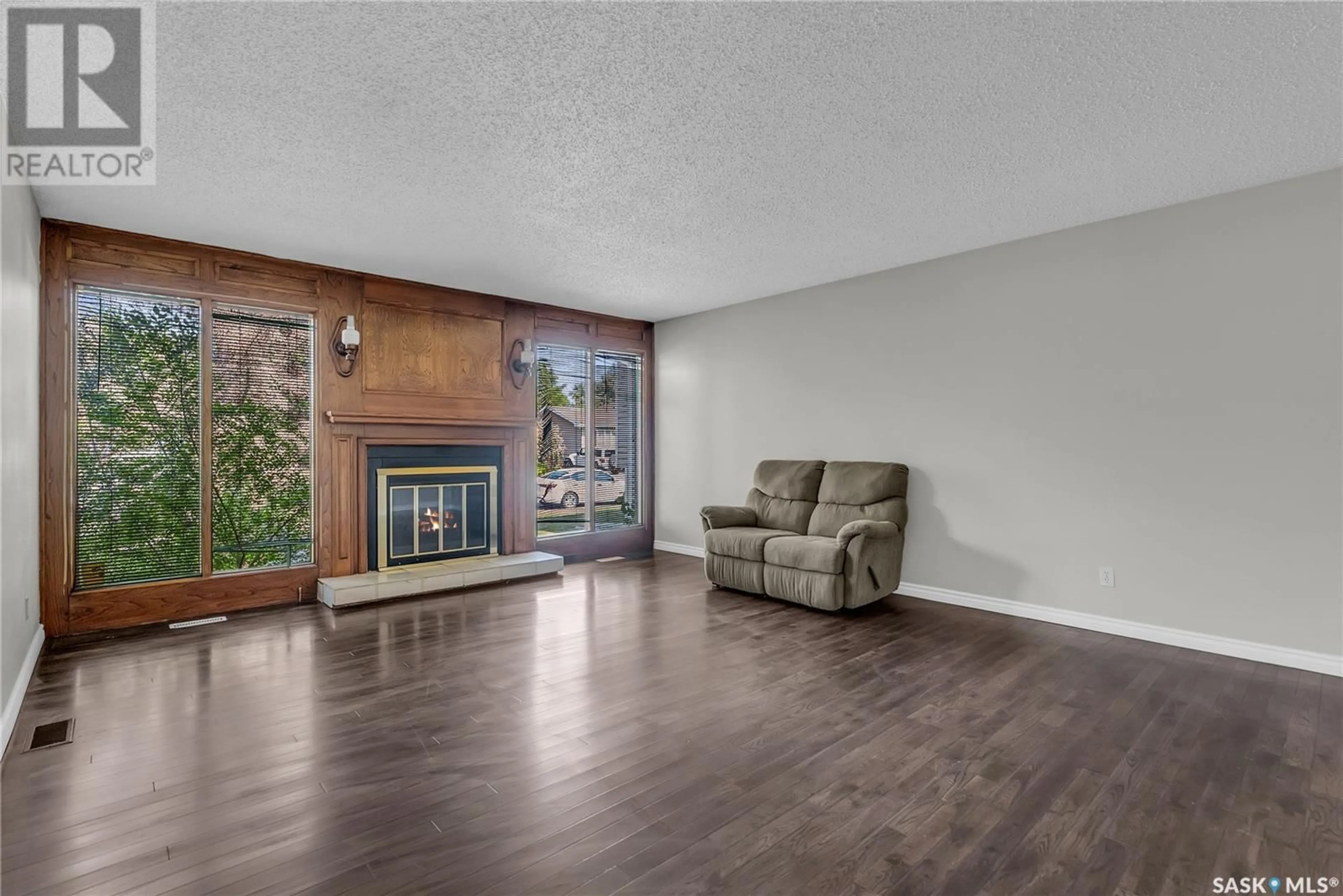 Living room with furniture, wood/laminate floor for 103 CYPRESS COURT, Saskatoon Saskatchewan S7K5C3