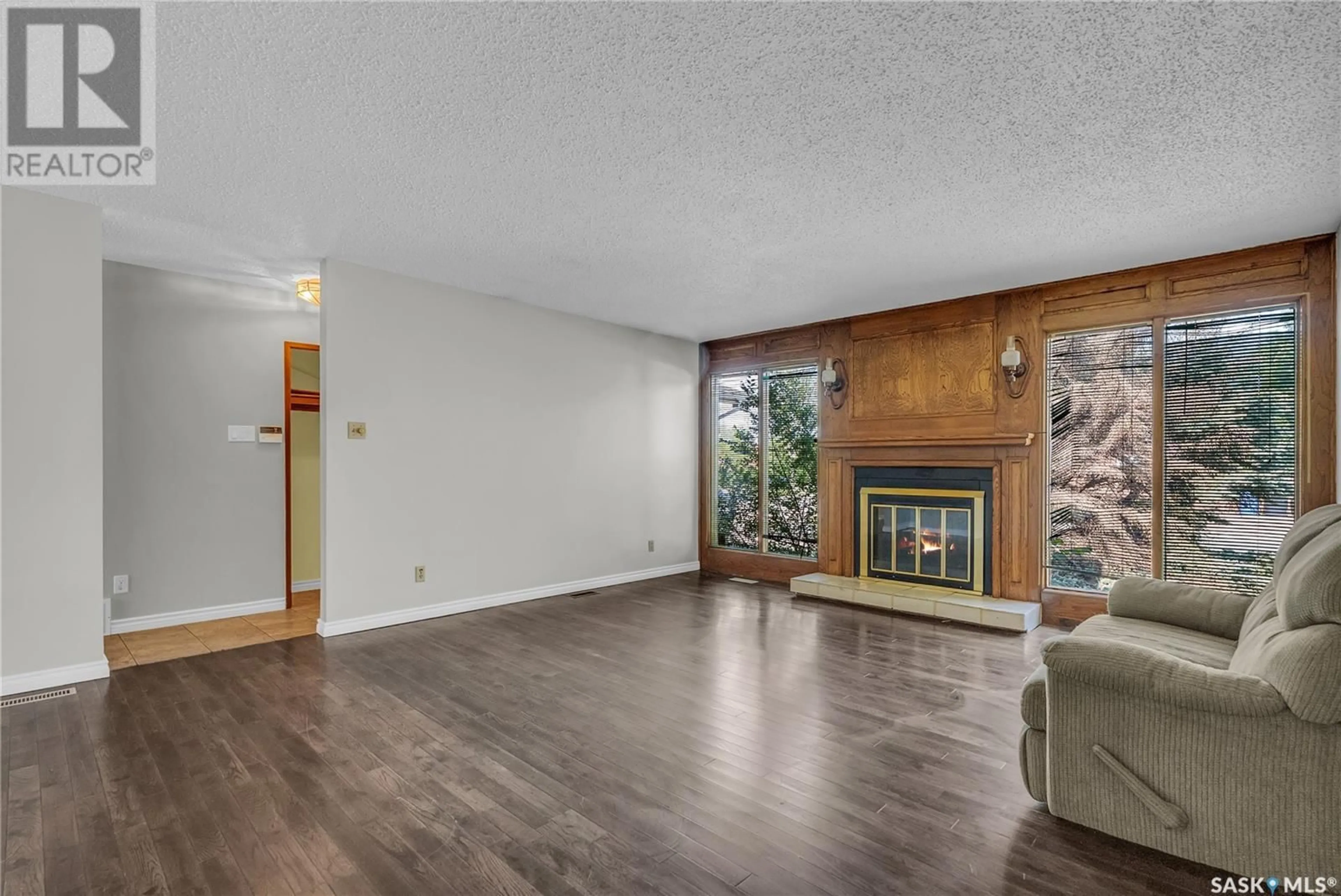 Living room with furniture, wood/laminate floor for 103 CYPRESS COURT, Saskatoon Saskatchewan S7K5C3