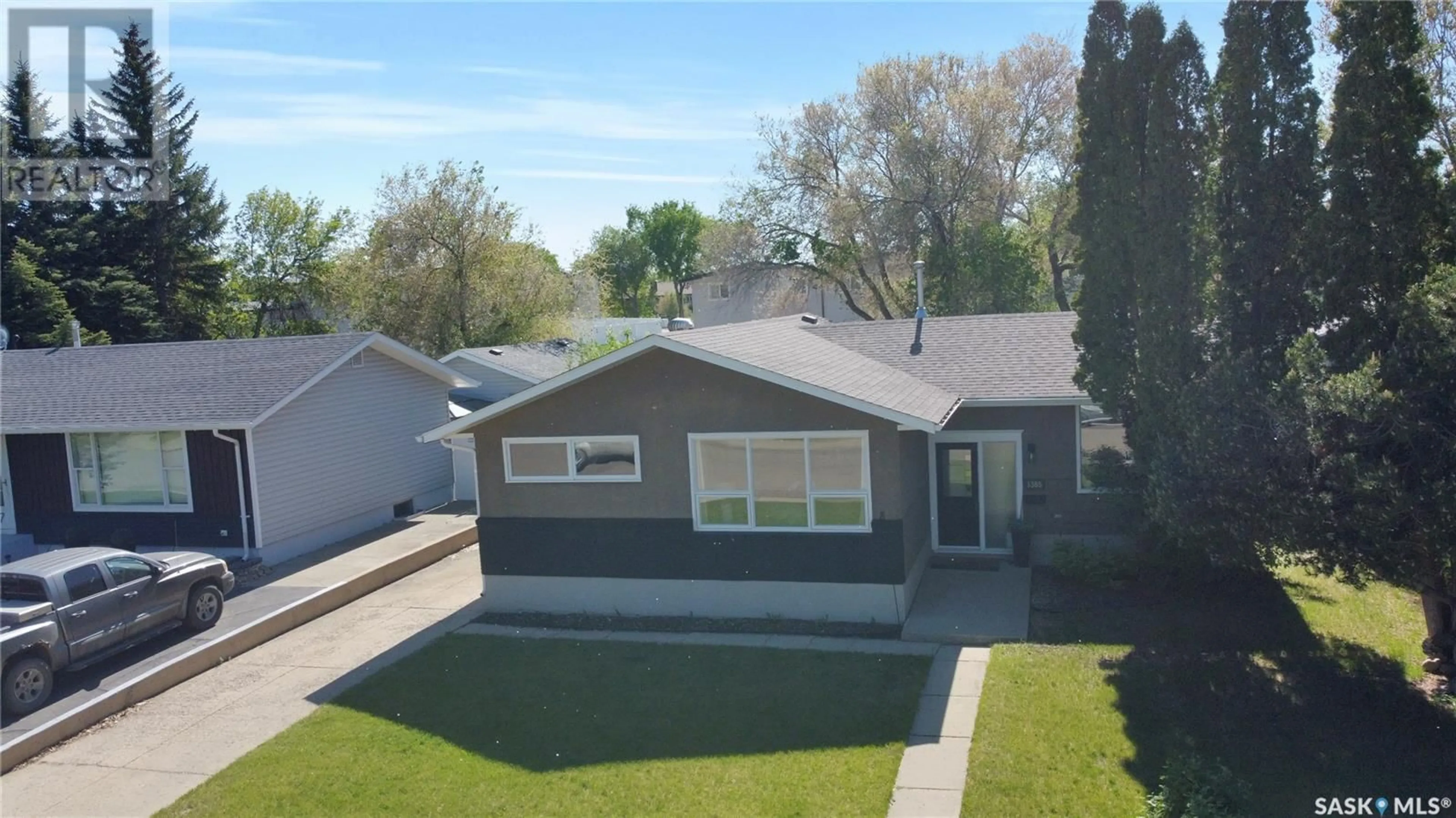 Home with vinyl exterior material, street for 1385 QUEEN CRESCENT, Moose Jaw Saskatchewan S6H3G5