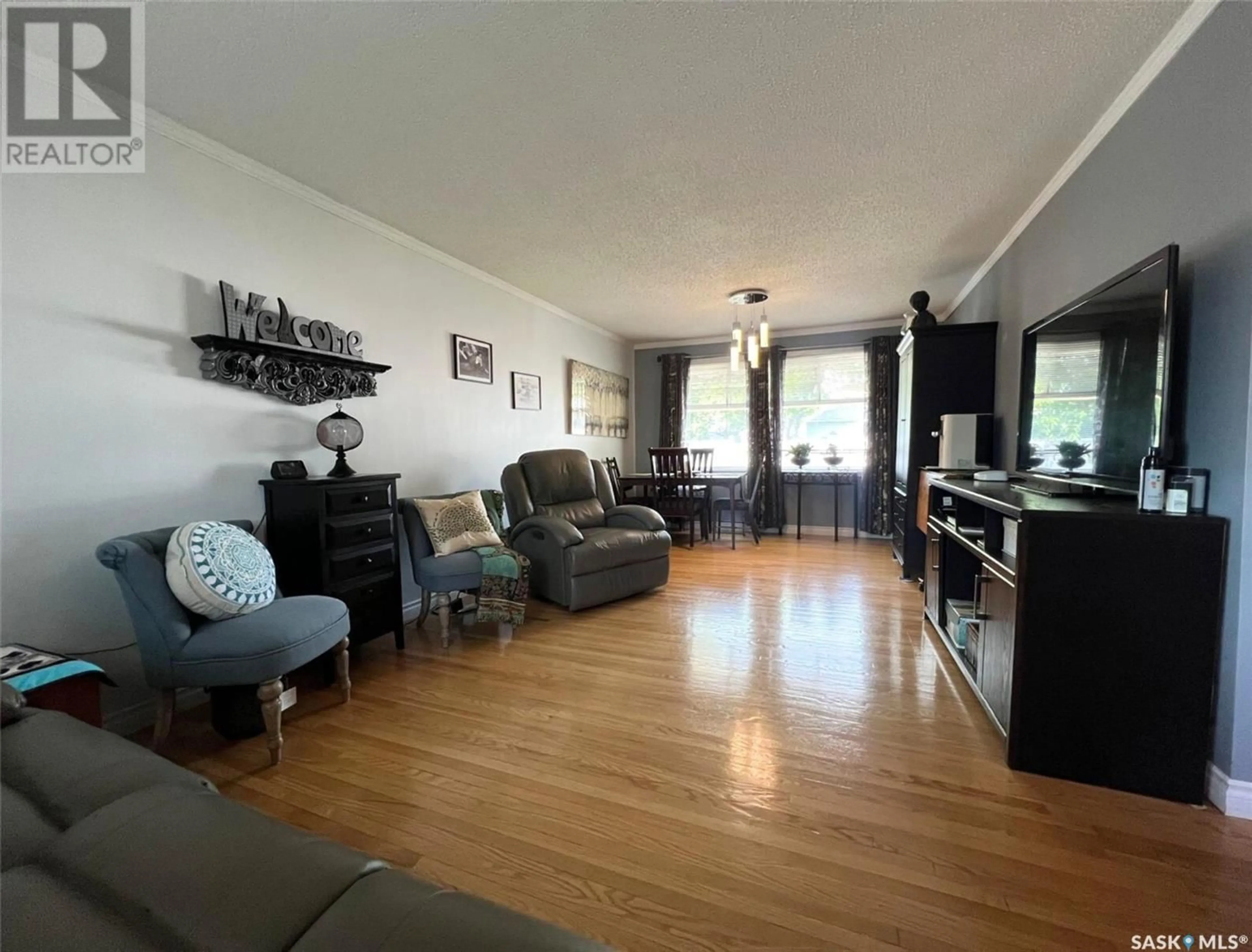 Living room with furniture, wood/laminate floor for 830 4TH AVENUE, Swift Current Saskatchewan S9H2K6