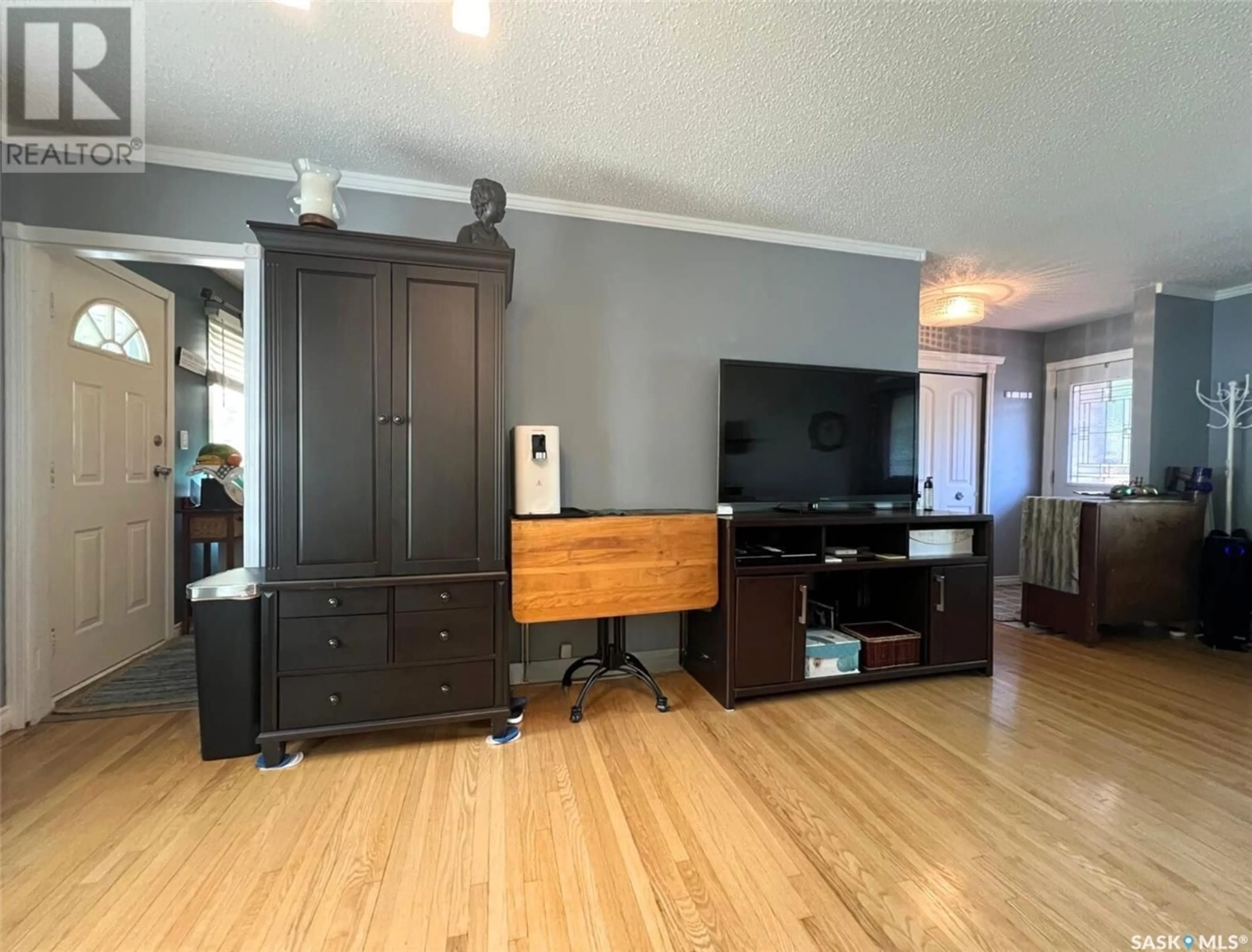 Living room with furniture, wood/laminate floor for 830 4TH AVENUE, Swift Current Saskatchewan S9H2K6