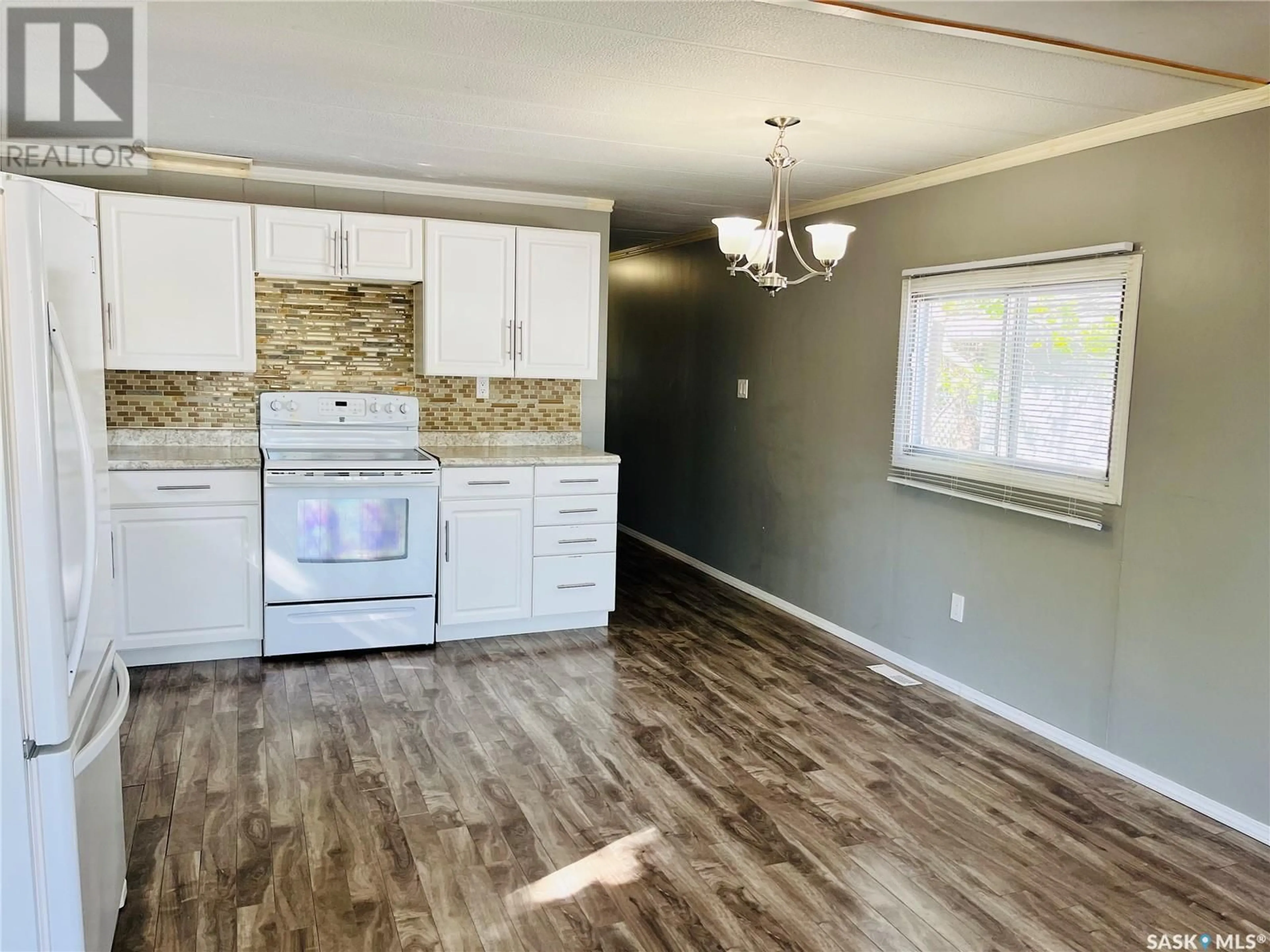 Open concept kitchen, wood/laminate floor for 34 ROYAL HEIGHTS, Estevan Saskatchewan S4A2T8