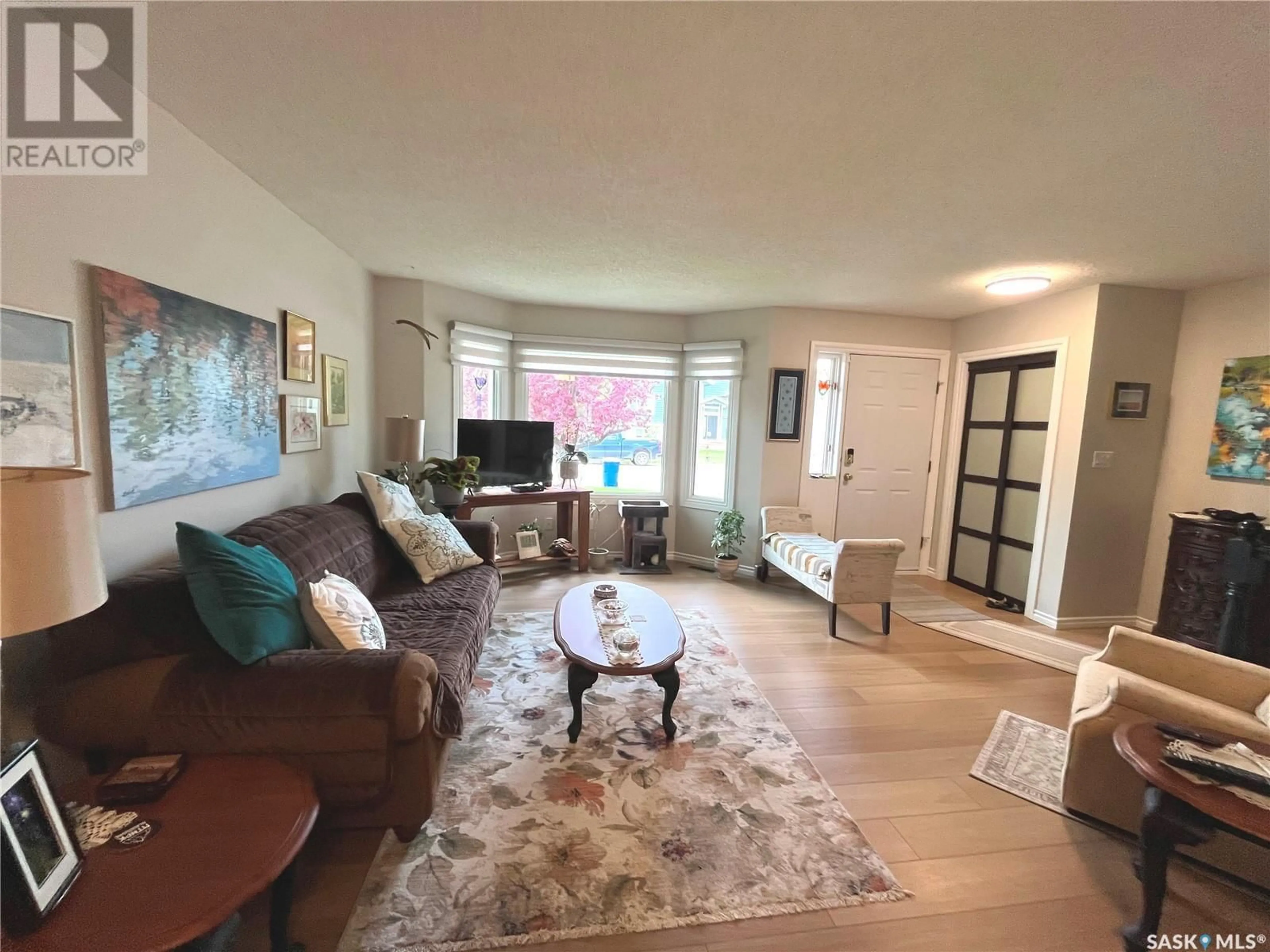 Living room with furniture, wood/laminate floor for 315 HUDSON AVENUE, Fort Qu'Appelle Saskatchewan S0G1S0