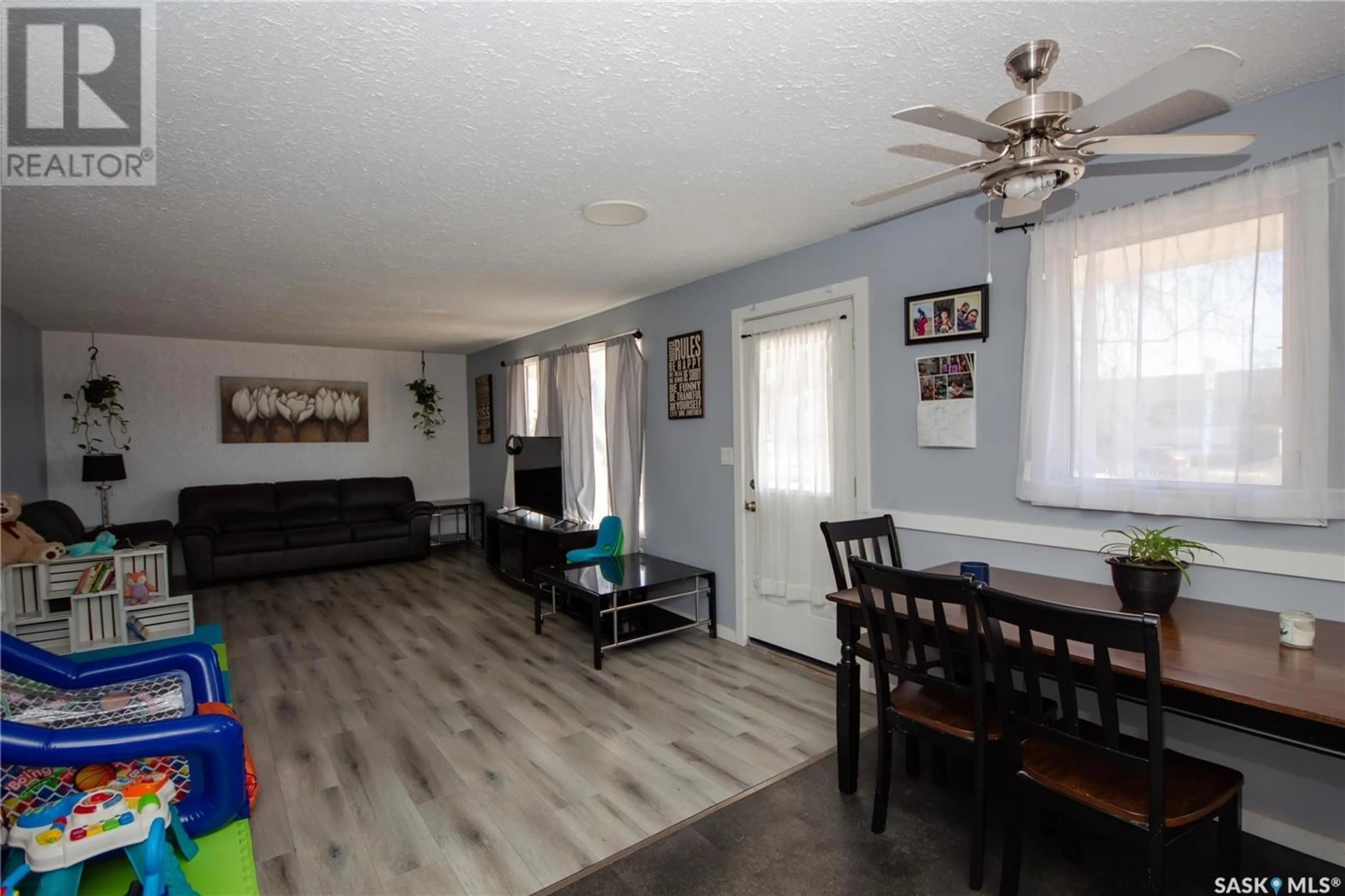Living room with furniture, wood/laminate floor for 52 22ND STREET, Battleford Saskatchewan S0M0E0