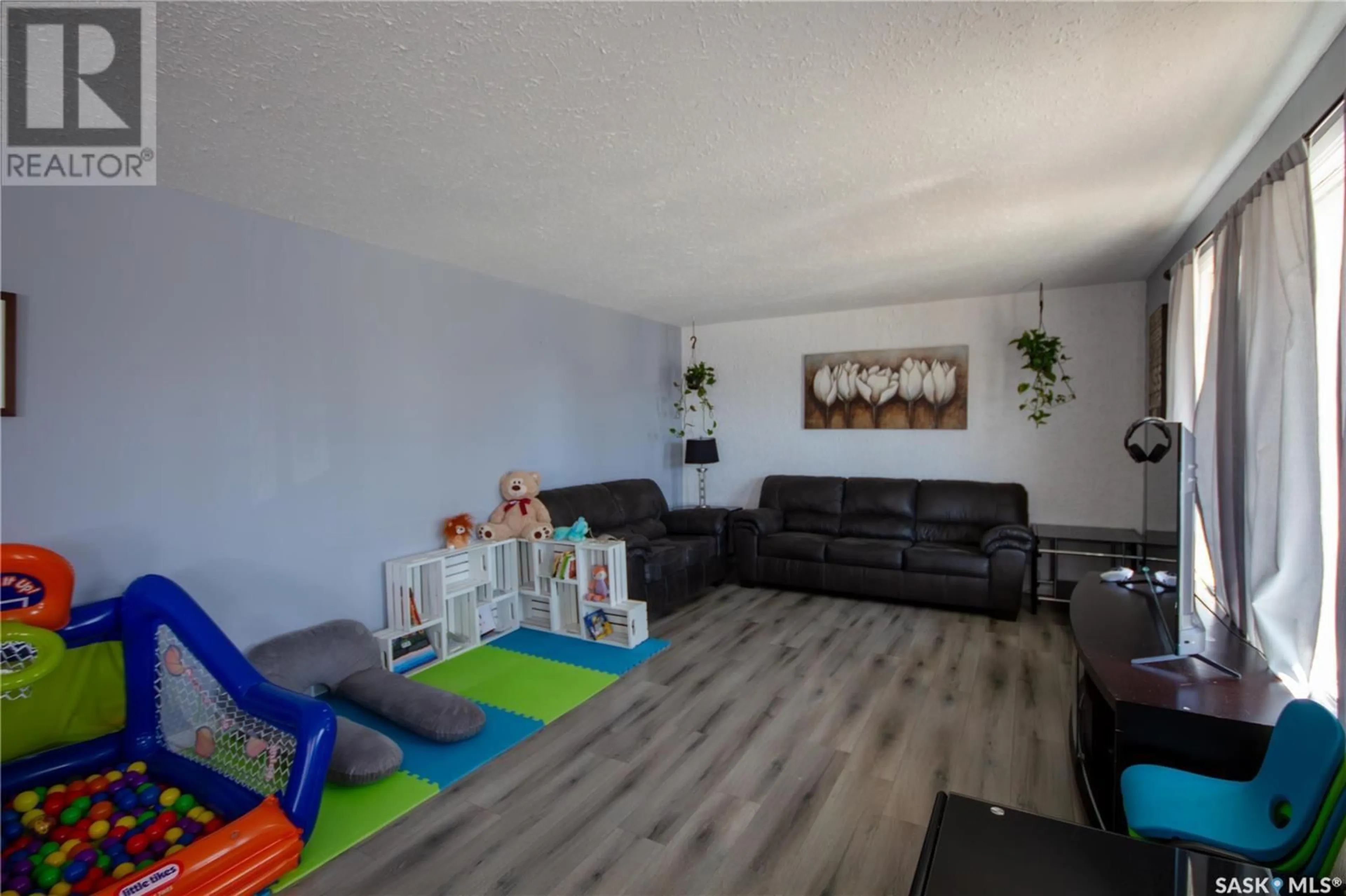 Living room with furniture, wood/laminate floor for 52 22ND STREET, Battleford Saskatchewan S0M0E0