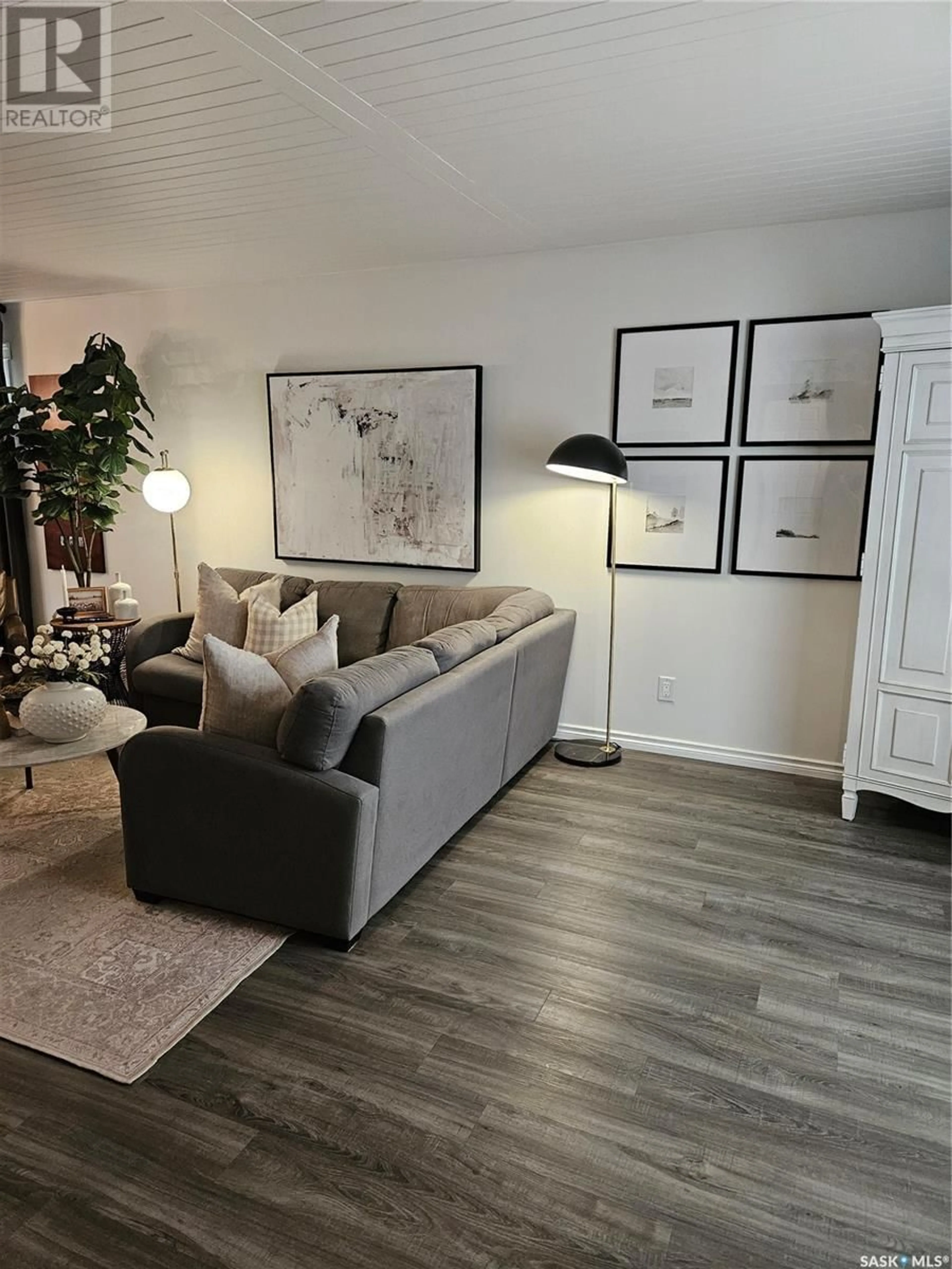 Living room with furniture, wood/laminate floor for 829 ALBERT STREET, Estevan Saskatchewan S4A1R9