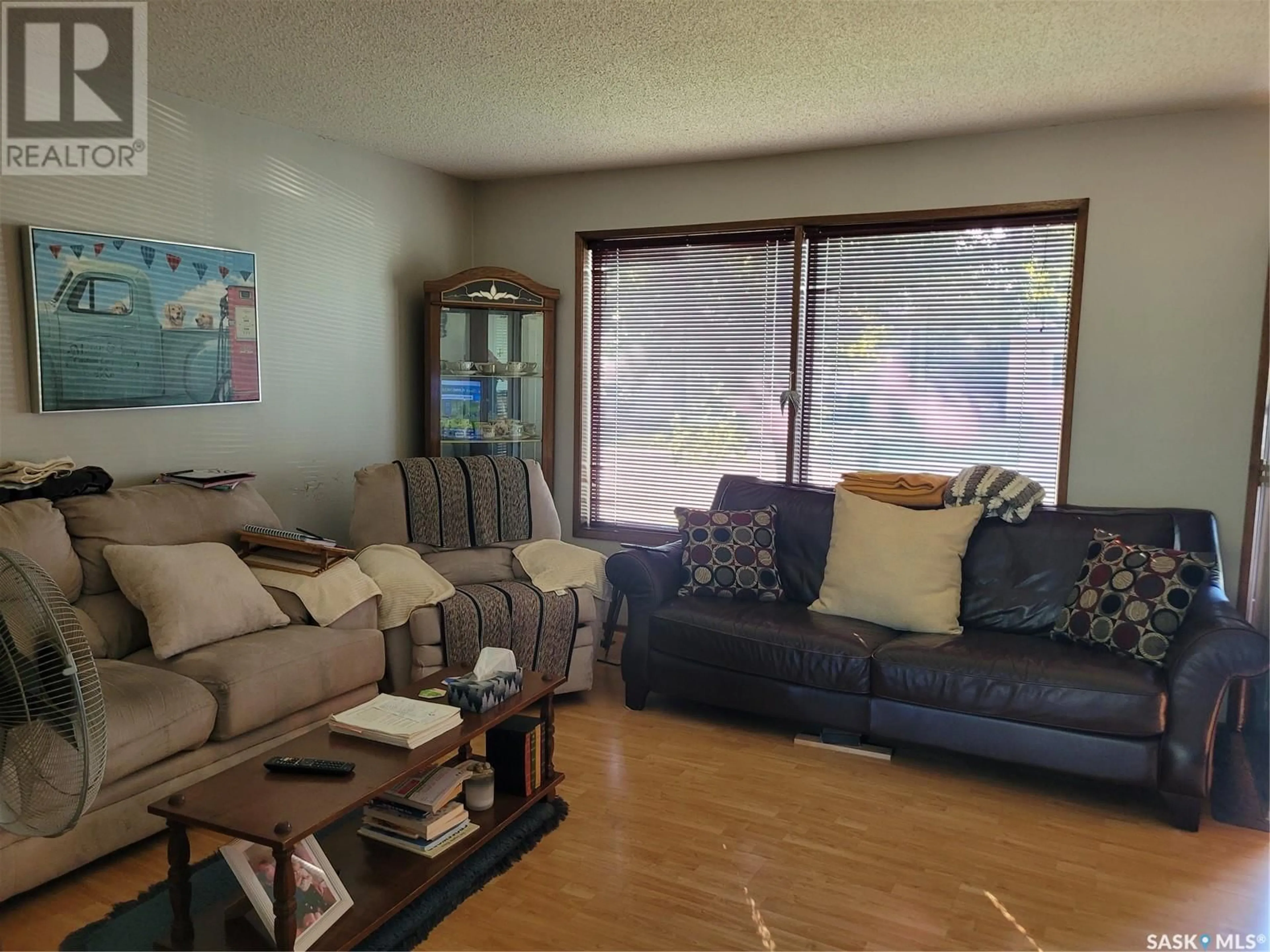 Living room with furniture, wood/laminate floor for 218 220 WAKABAYASHI WAY, Saskatoon Saskatchewan S7K7M2