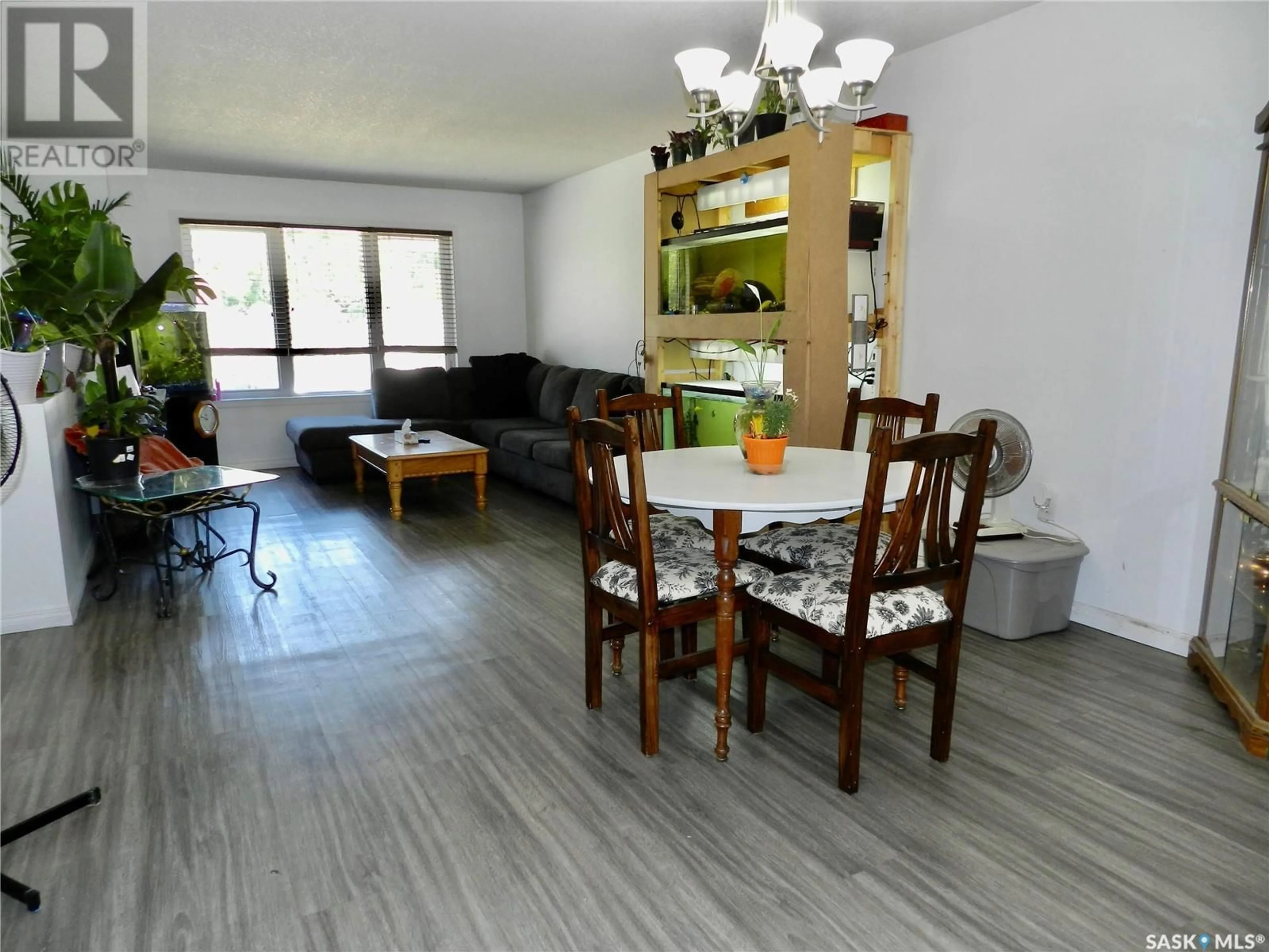 Living room with furniture, wood/laminate floor for 907 OMINICA STREET, Moose Jaw Saskatchewan S6H0J1
