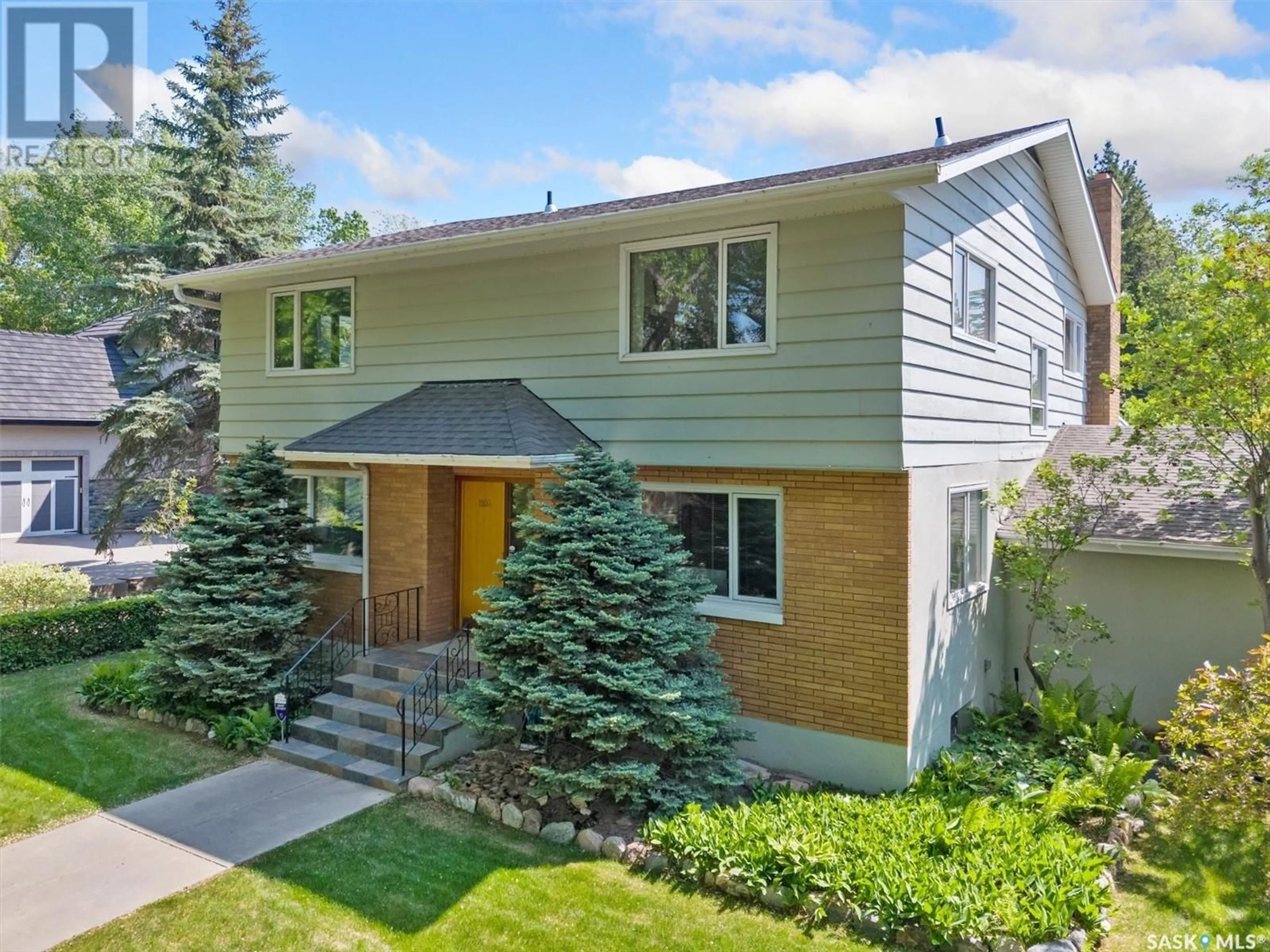 Home with vinyl exterior material, street for 1104 ELLIOTT STREET, Saskatoon Saskatchewan S7N0V3