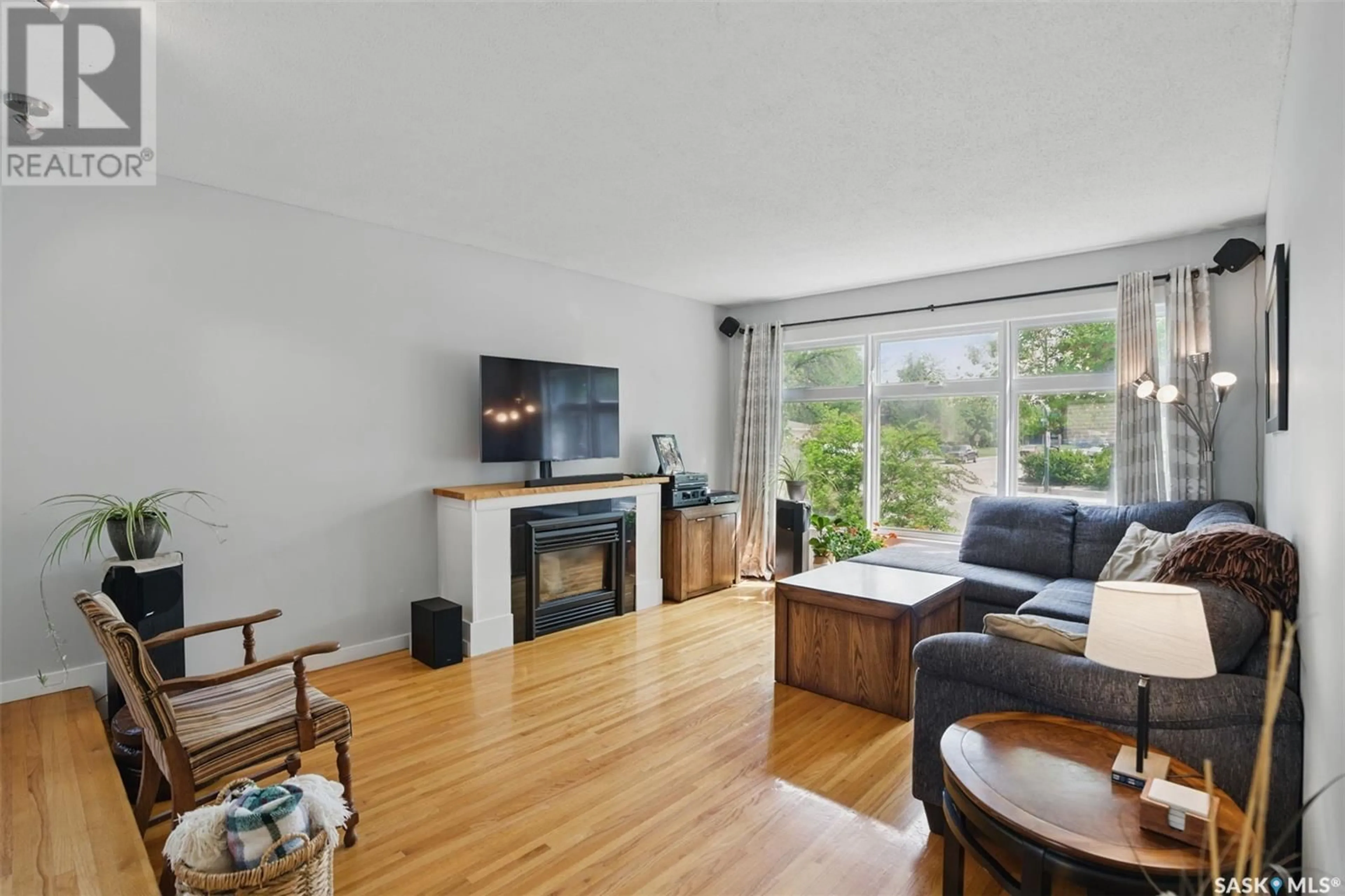 Living room with furniture, wood/laminate floor for 2812 ESTEY DRIVE, Saskatoon Saskatchewan S7J2V7